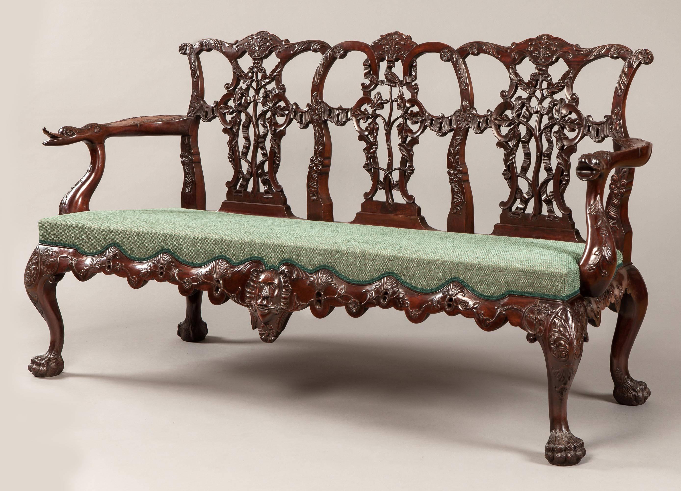 A pair of triple back settees In the mid-Georgian Chippendale manner

Constructed in a richly carved, well patinated mahogany; rising from cabriole front & rear legs, terminating in ‘hairy paw’ shoes, the perforated seat rails carved with