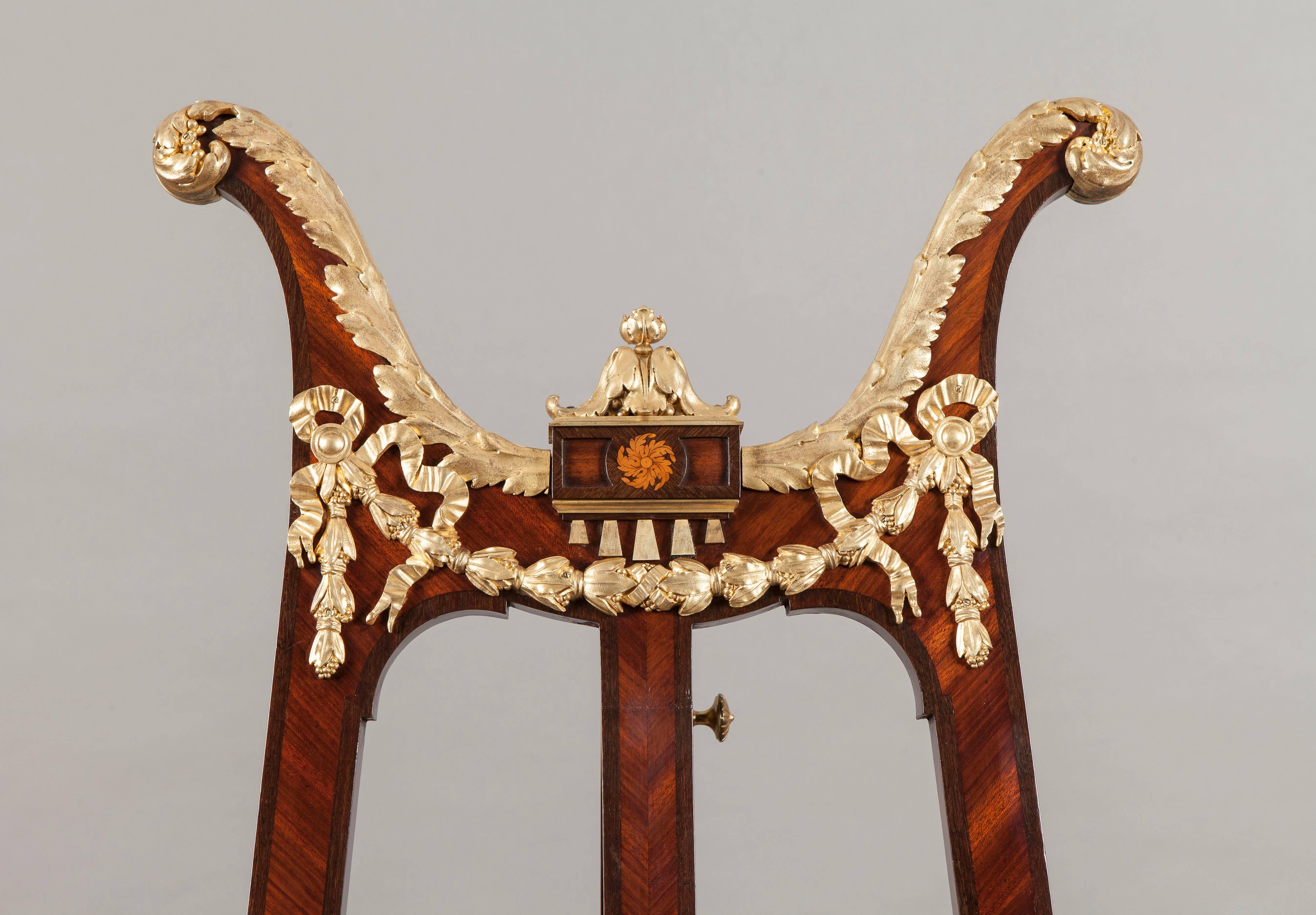An ormolu-mounted easel.

Constructed in kingwood with tulipwood crossbanding and inlaid on the central strut with paterae, having gilt bronze mounts of the highest quality; the ‘A’ form frame having gilt bronze shod swept feet, an adjustable