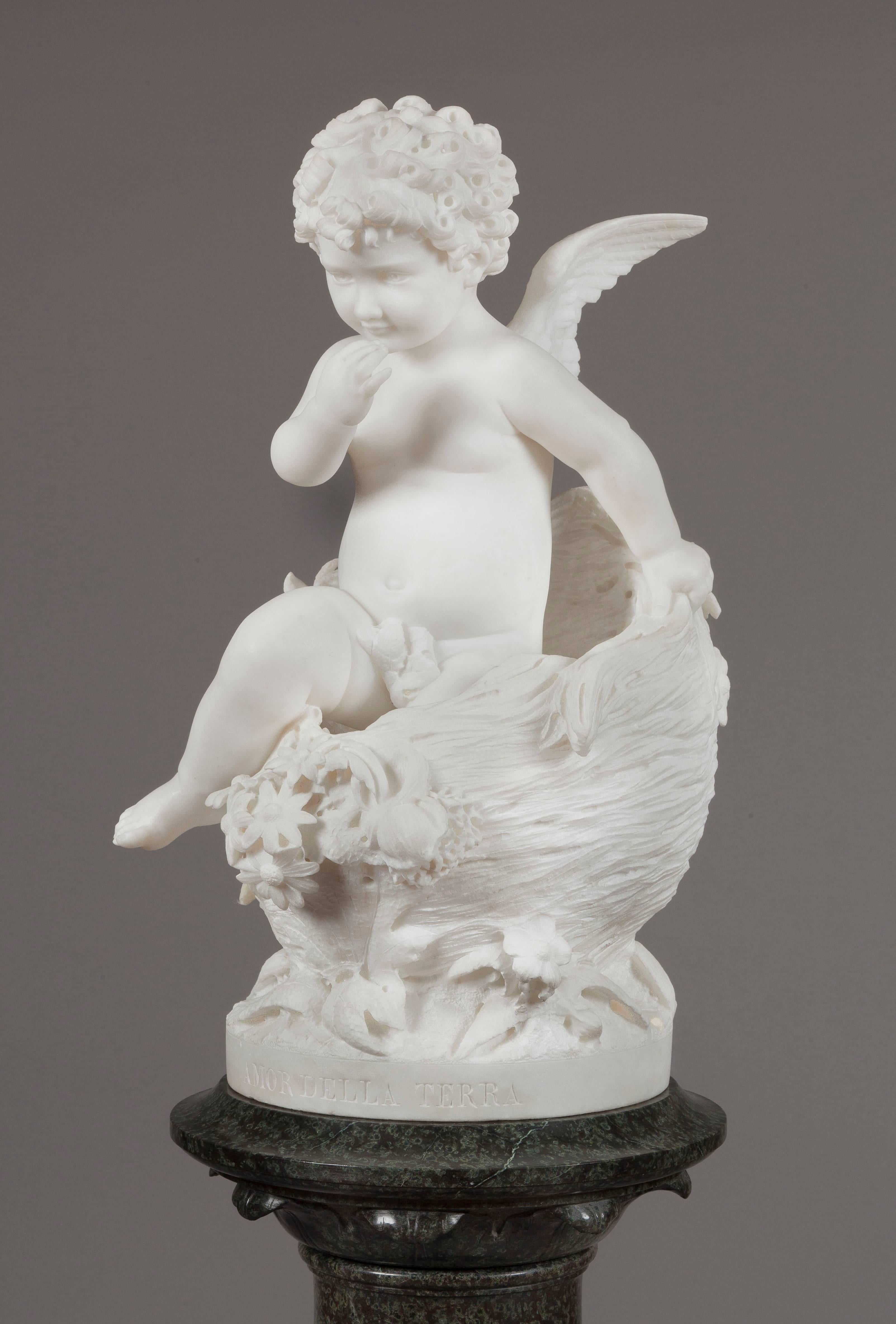 Standing on a turned Verte de Mer circular pedestal, the subject, sculpted in white Carrara marble, the ‘Love of the land’ Cupid emerges from a sylvan cocoon, adorned with foliage and foliates. Entitled to the front, and signed and dated 1885