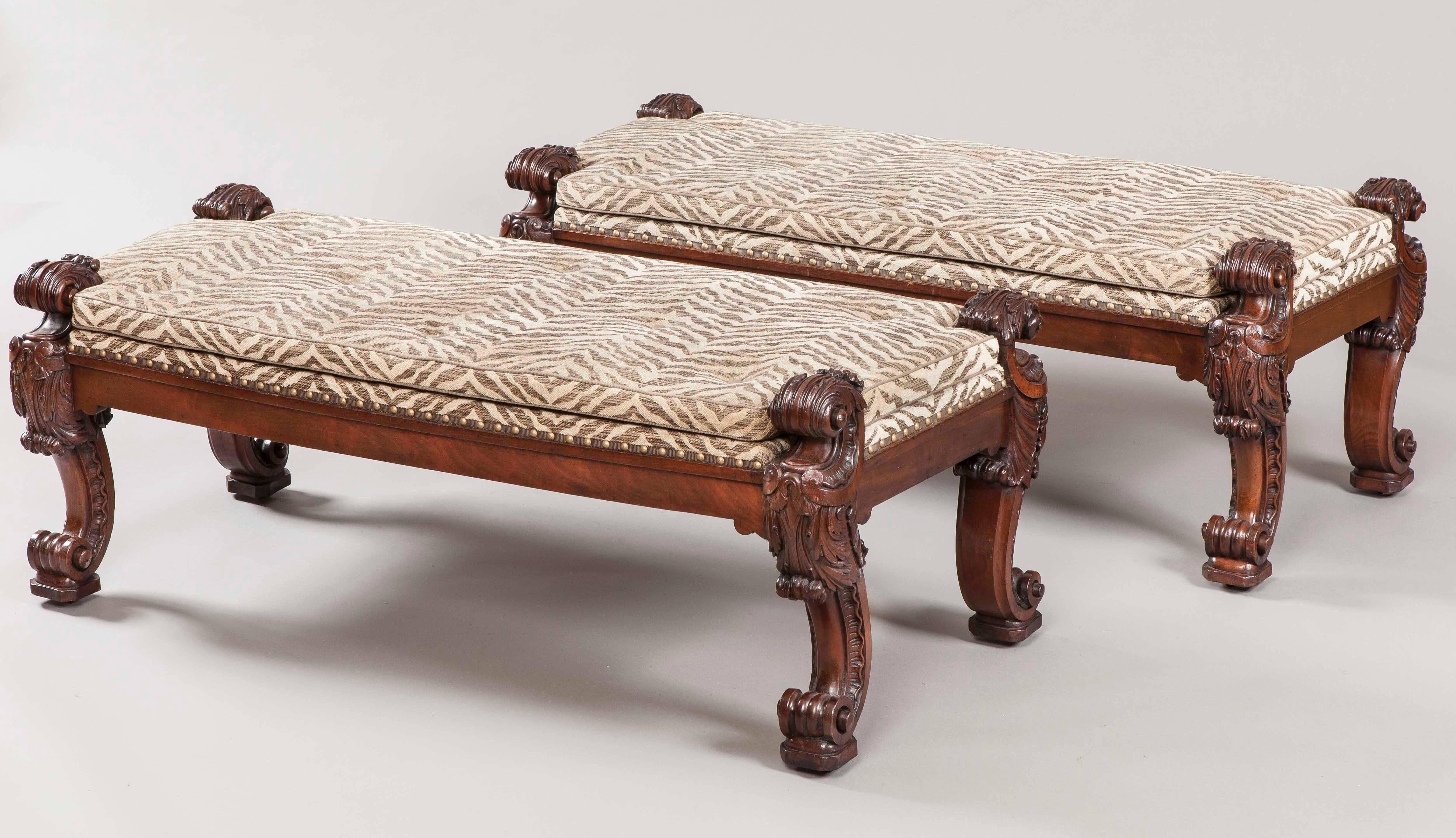 A Pair of Georgian stools firmly attributed to Gillows of Lancaster.

Constructed in a well patinated and very finely carved mahogany; of rectangular, but lightly canted form, rising from swept legs, profusely carved with acanthus motifs and