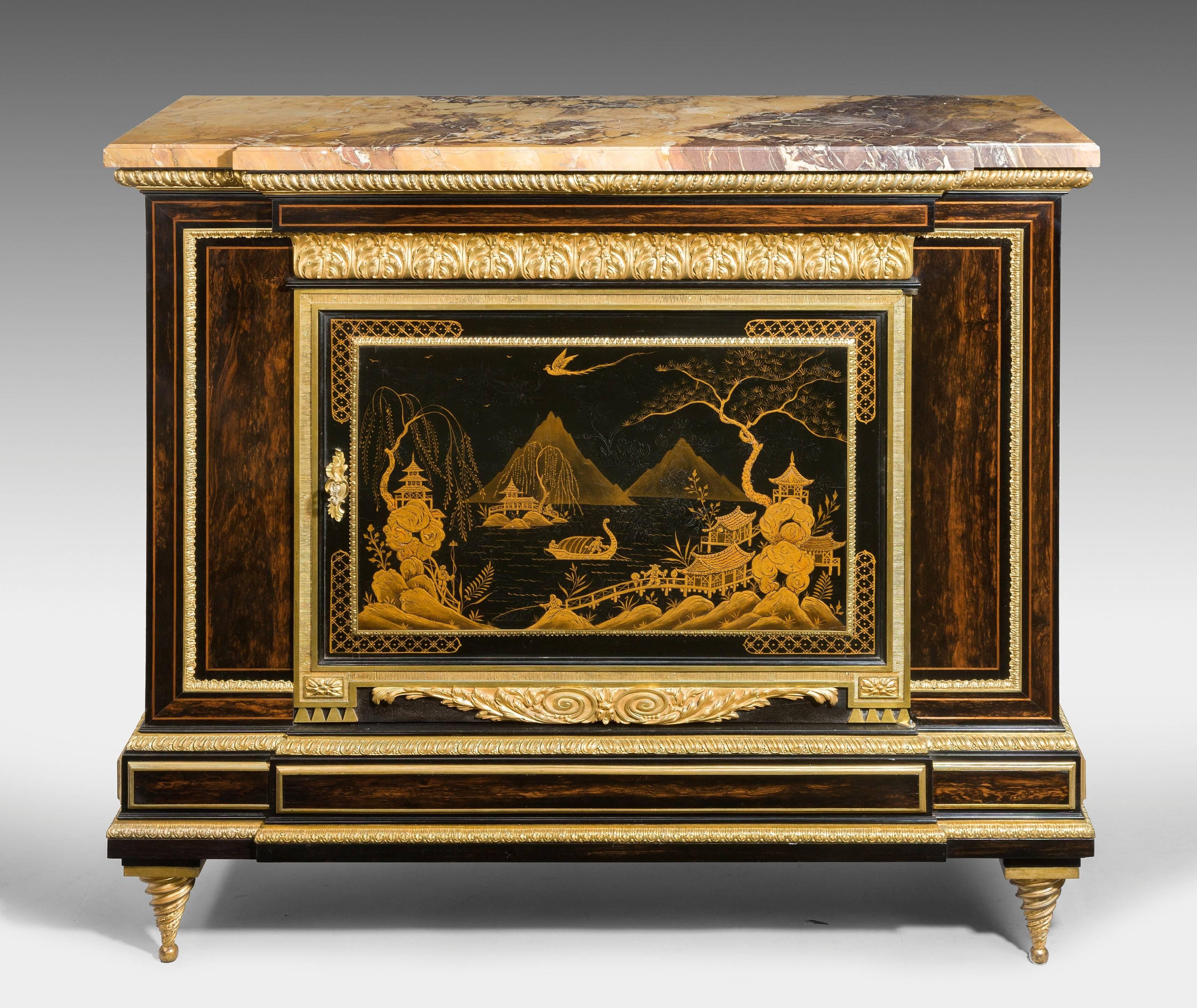 An exhibition quality Gillows Coromandel side cabinet.

The rectangular marble top above a central cupboard door with an English decorated japanned panel in the Chinese taste, with a gilt landscape on a black ground, applied with superb quality