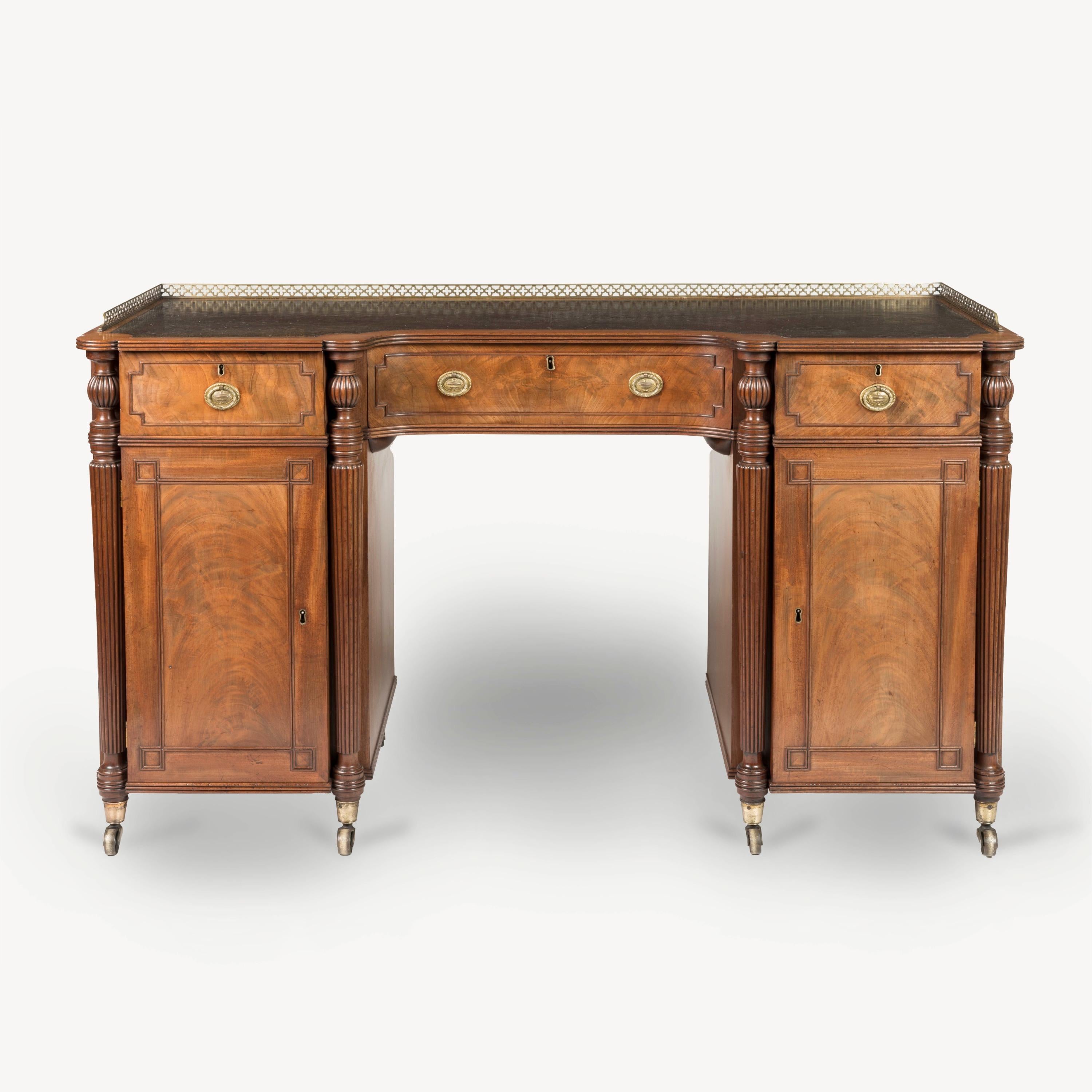 A Fine Mahogany Pedestal Desk
Attributed to Gillow & Co

Constructed from figured mahogany, the desk rising from brass castor-shod feet, the pedestals with lockable doors dressed with re-entrant rectangular cock bead mouldings enclosing cupboards,