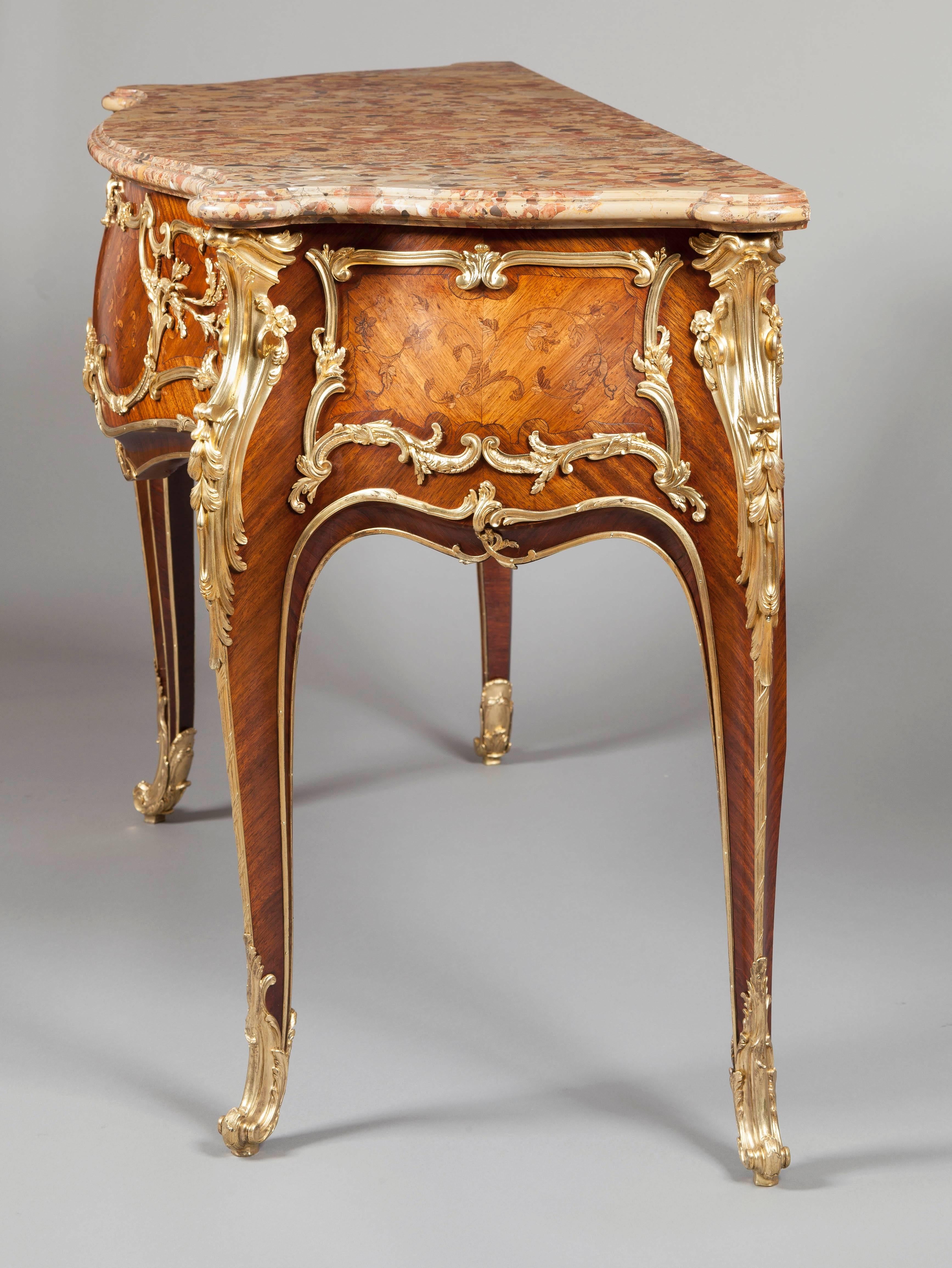 
A French commode in the Louis XV manner Attributed to J.E. Zwiener

of serpentine fronted, ‘sauteuse’ form, constructed in kingwood with fine marquetry foliate work, and dressed with gilt bronze mounts; rising from cabriole legs, with the swept