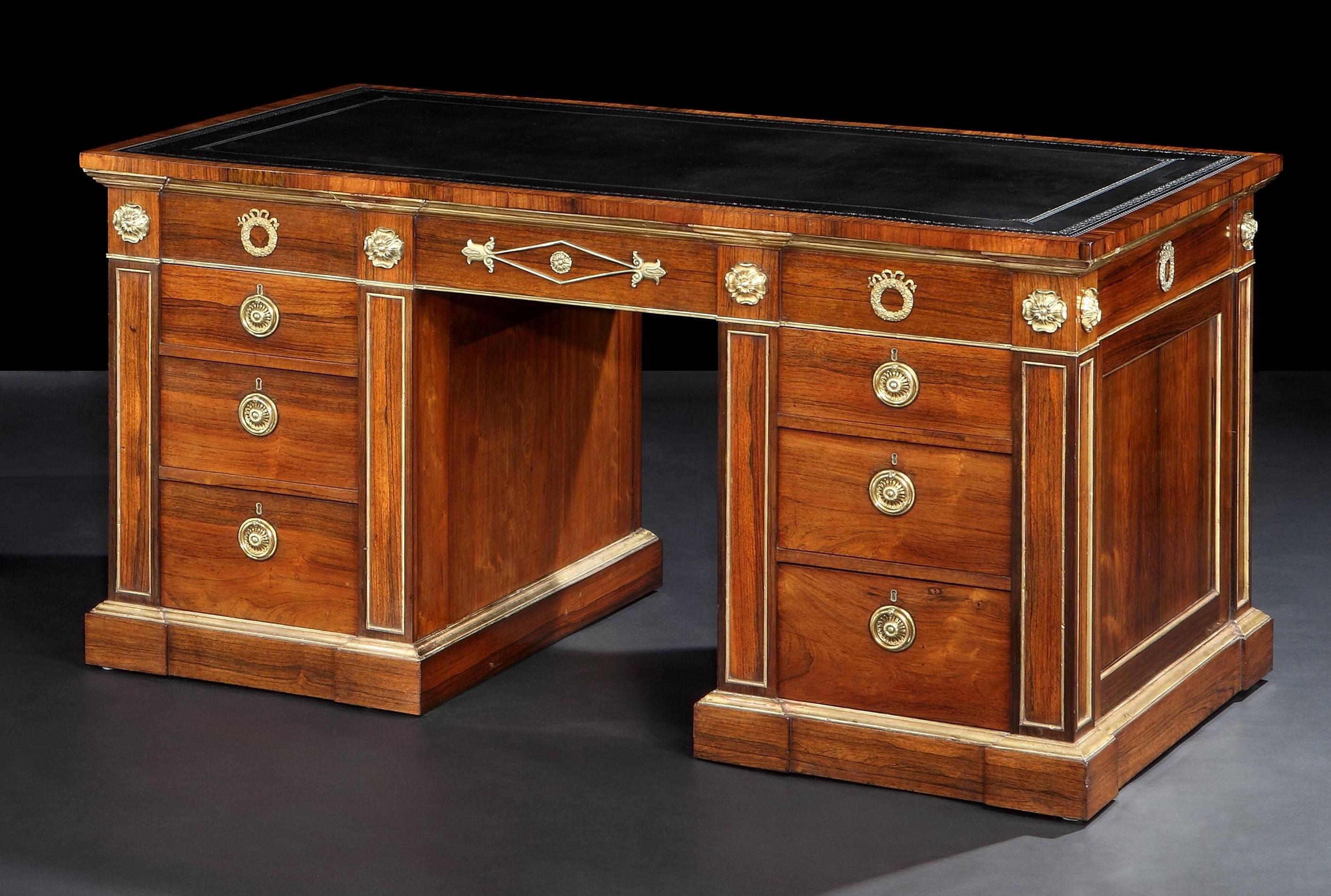 Fine Pair of Antique Pedestal Desks in the Regency Manner

Constructed in goncalo alves, with gilt bronze mounts and giltwood highlights, of freestanding form, with very gentle inverted breakfront plinths, each pedestal housing three cedar lined