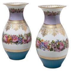 A Pair of Parcel Gilt Porcelain Vases with painted flowers