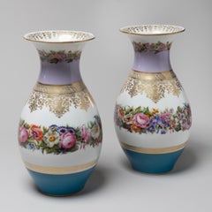A Pair of Parcel Gilt Porcelain Vases with painted flowers