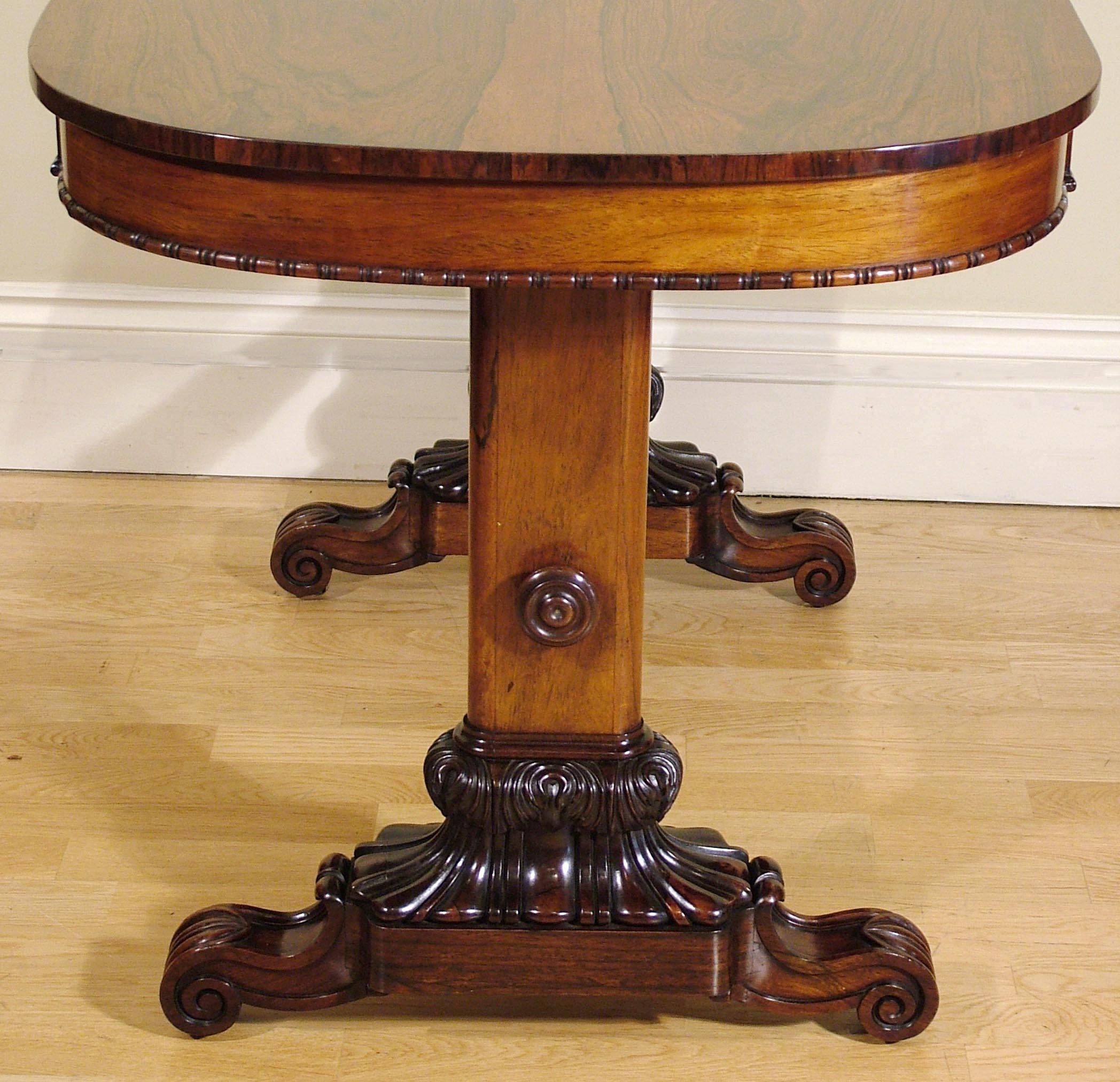 A Fine Library Table in the manner of Gillows of Lancaster

Constructed in a very fine and distinctively marked Brazilian goncalo alves; of end support form, rising from a scrolled slab base, adorned with lapetting to the toes, lobed feet issuing