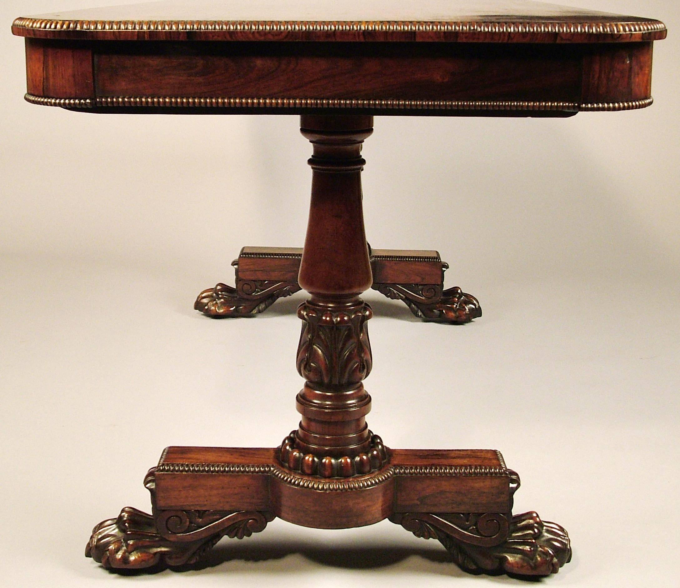 A fine end support table firmly attributed to Gillows of Lancaster.

Constructed in a well figured Goncalo Alves, rising from winged lions claw feet supporting the base platforms; the end columns issuing from a circular plinth, tapering, turned