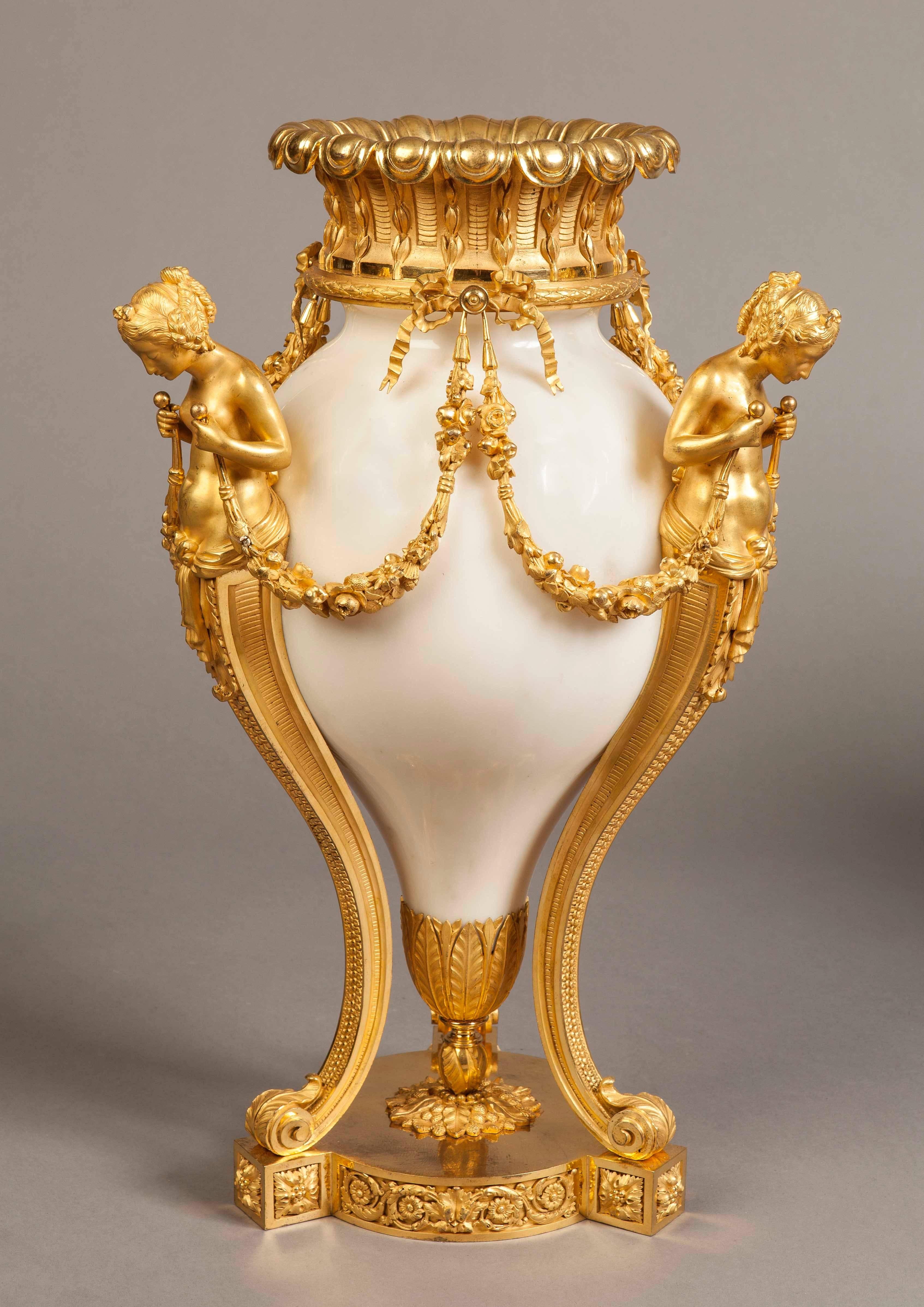 A Superb Pair of Vases in the Louis XVIth Manner

Constructed in Carrara marble and two color ormolu of the finest quality, each of the circular bases supporting three female herms, rising from scrolls, dressed with running guilloches, and