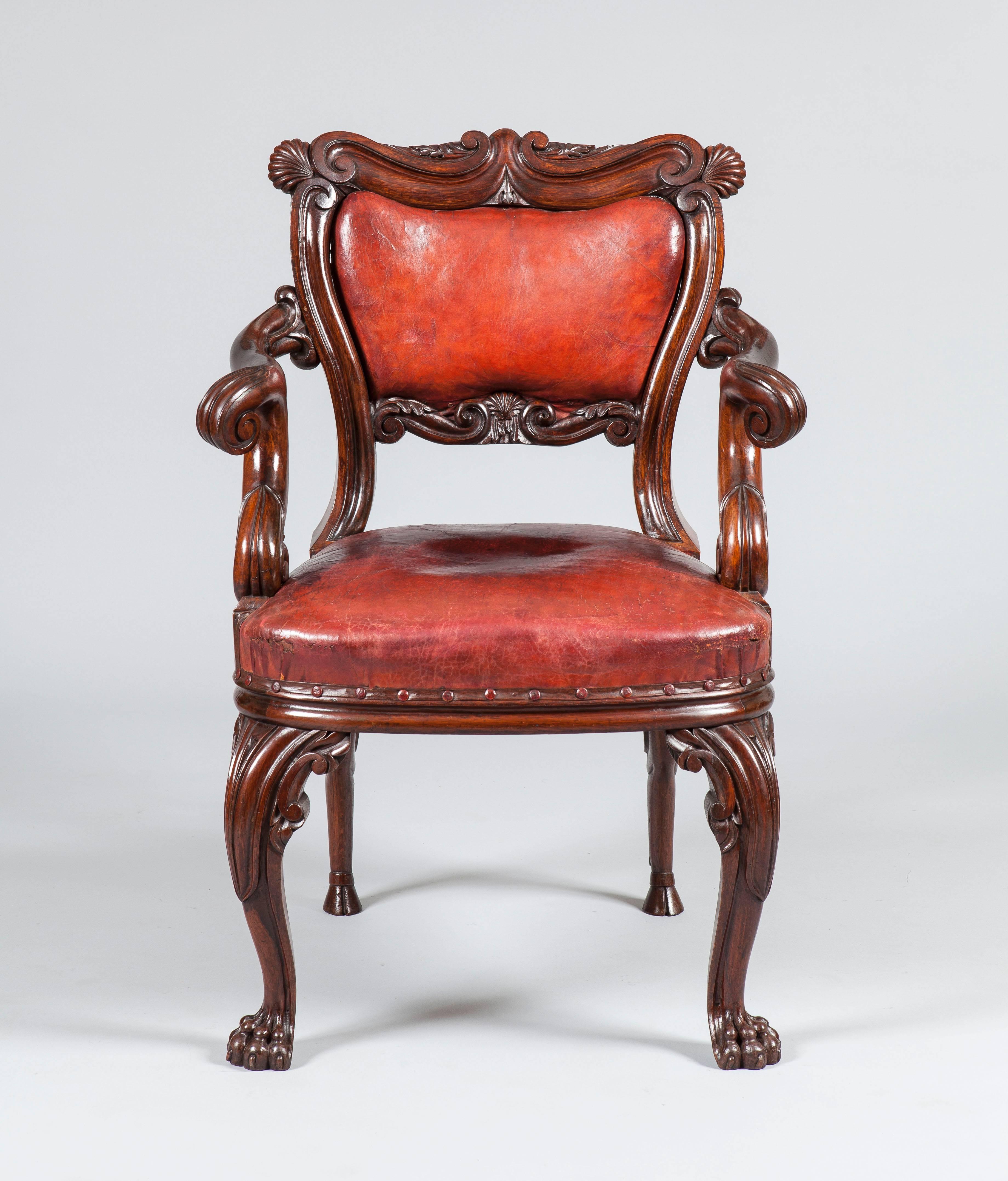 An Irish armchair in the manner of Williams and Gibton

Constructed in oak, rising from cabriole front legs channeled and carved with scrolls, terminating in claw feet, the rear legs of equine form, with hoof feet, the channeled seat back having a
