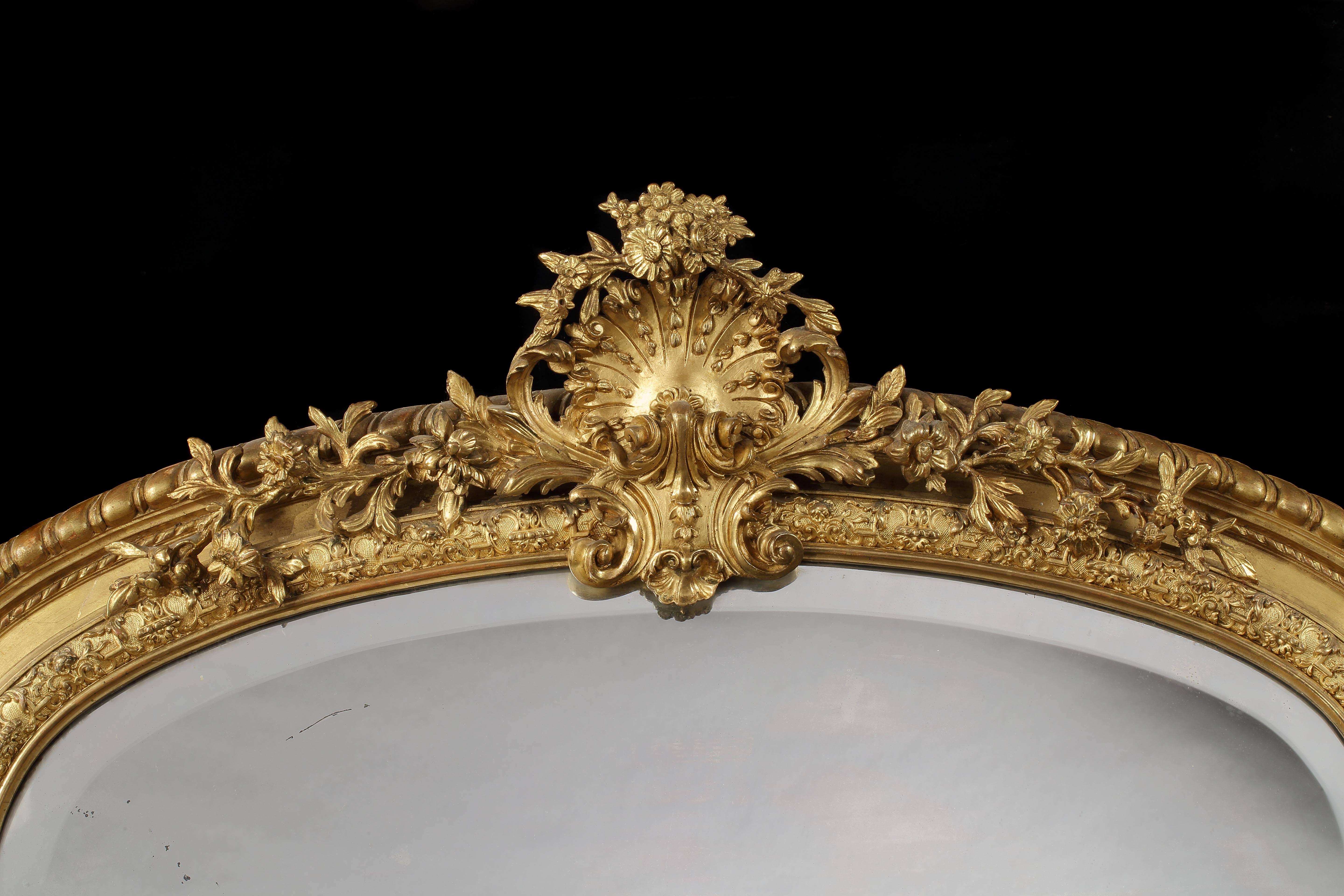 A fine pier mirror of imposing size.

The domed top plate enclosed by a giltwood frame, dressed with exuberant scroll work, and surmounted by a gadrooned toprail bearing a shell motif, issuing foliates,
English, circa 1870.

Provenance provided