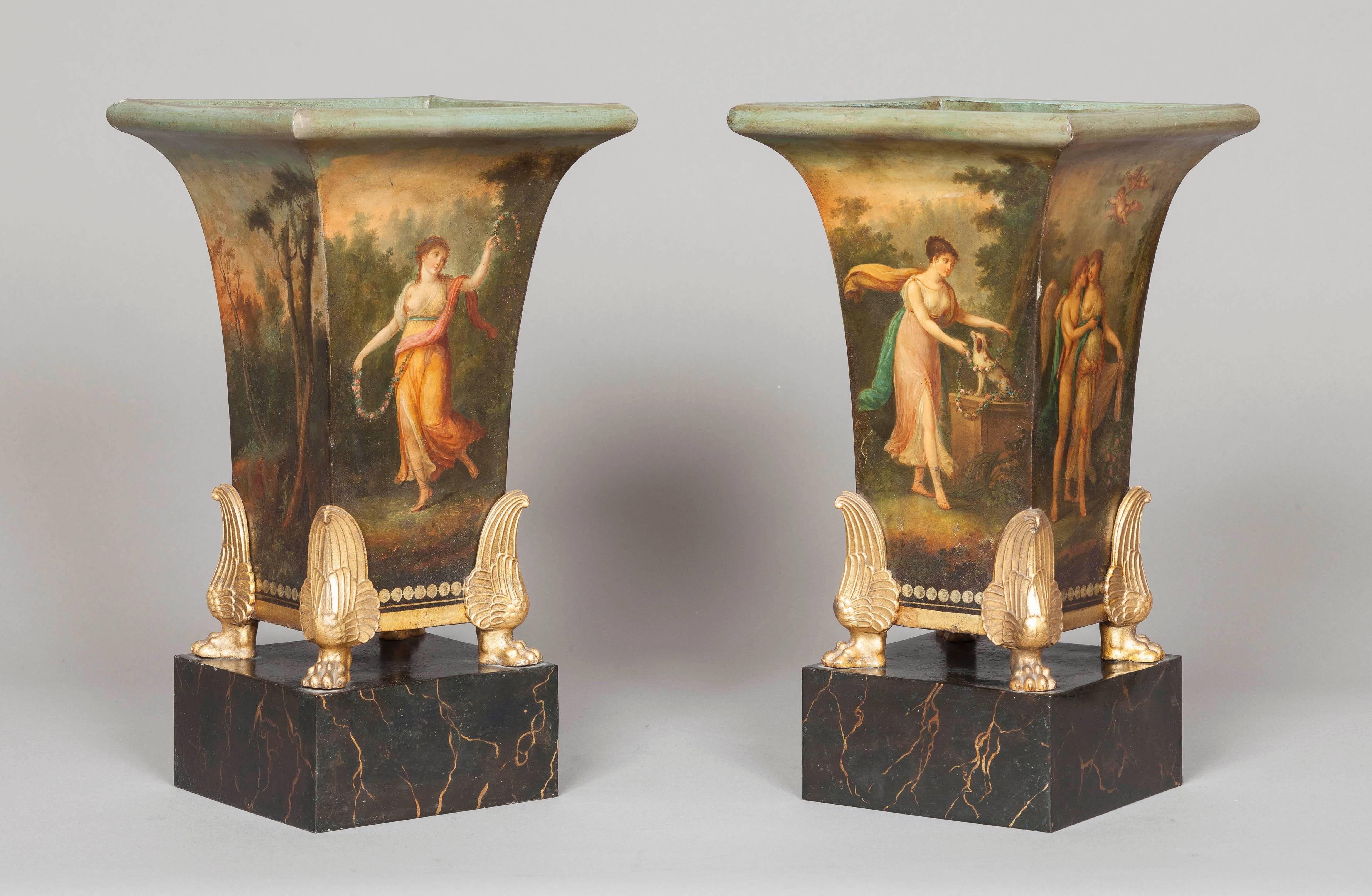 A Three Piece Jardinière Garniture of the Empire Period

Constructed in tole, being hand painted and decorated in the French Empire Neo-Classical manner of Jacques-Louis David; the bases decorated in faux marble, the central, larger jardinière