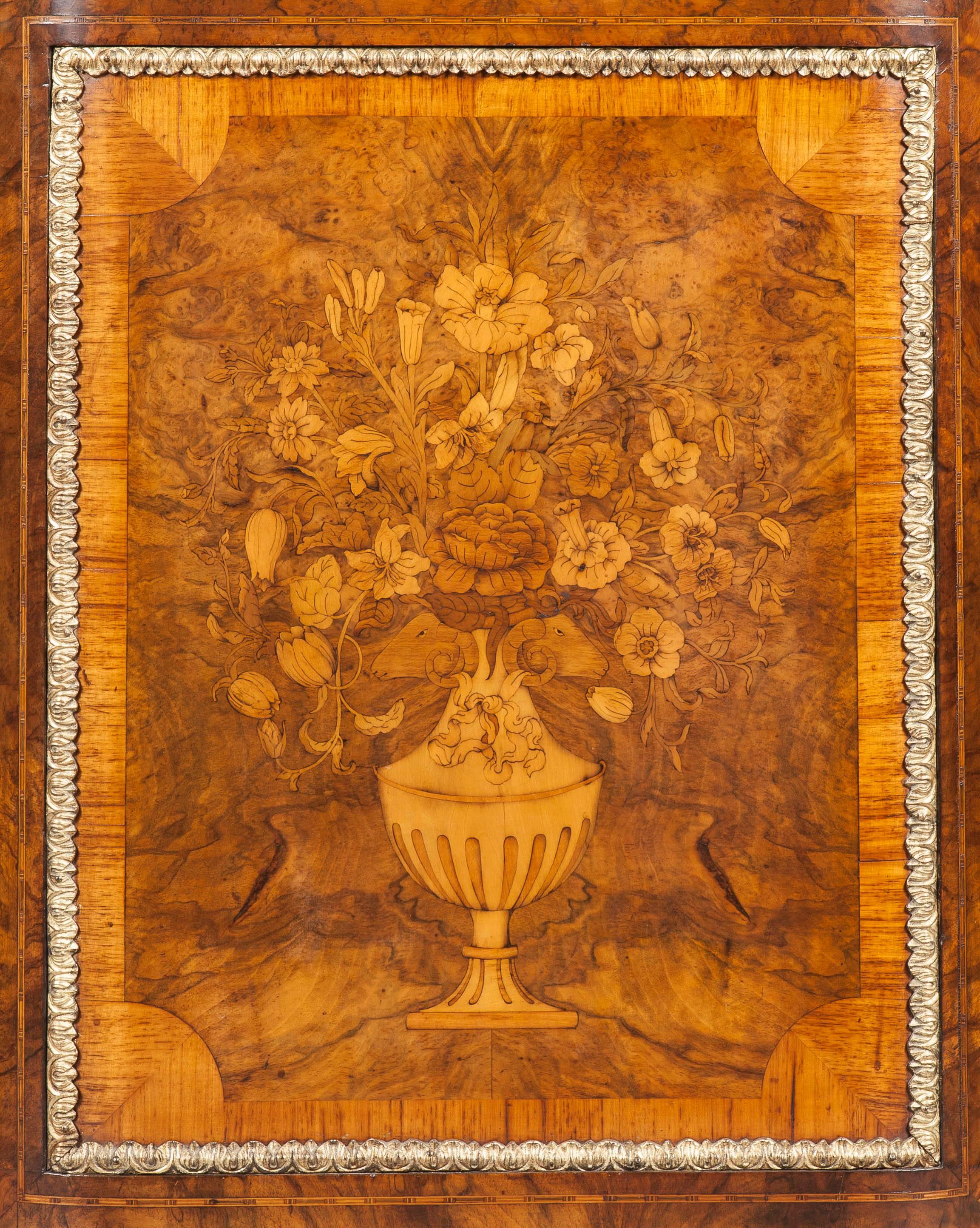 Floral marquetry and bronze-mounted credenza.

Constructed in walnut with fine marquetry specimen wood inlays and dressed with bronze mounts of serpentine, three-door form, rising from a shaped plinth base capped with a running bronze ovolo