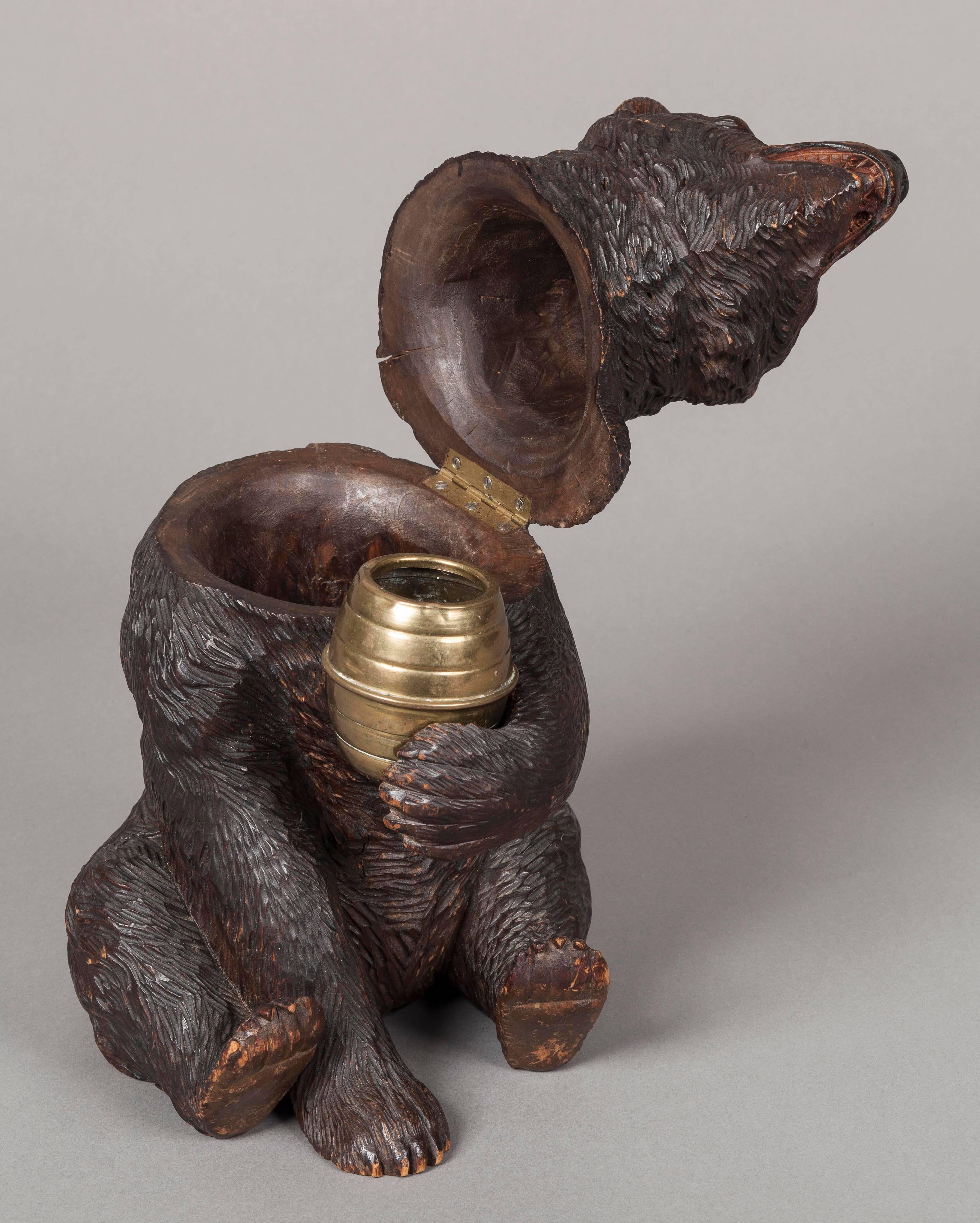 A Black Forest tobacco Jar

Constructed in carved linden wood, the naturalistically carved bear, with glass eyes grasps a brass spill pot, the hinged head disclosing the interior.
Brienz, Bernese Oberland,
circa 1900

Brienz, in the Bernese