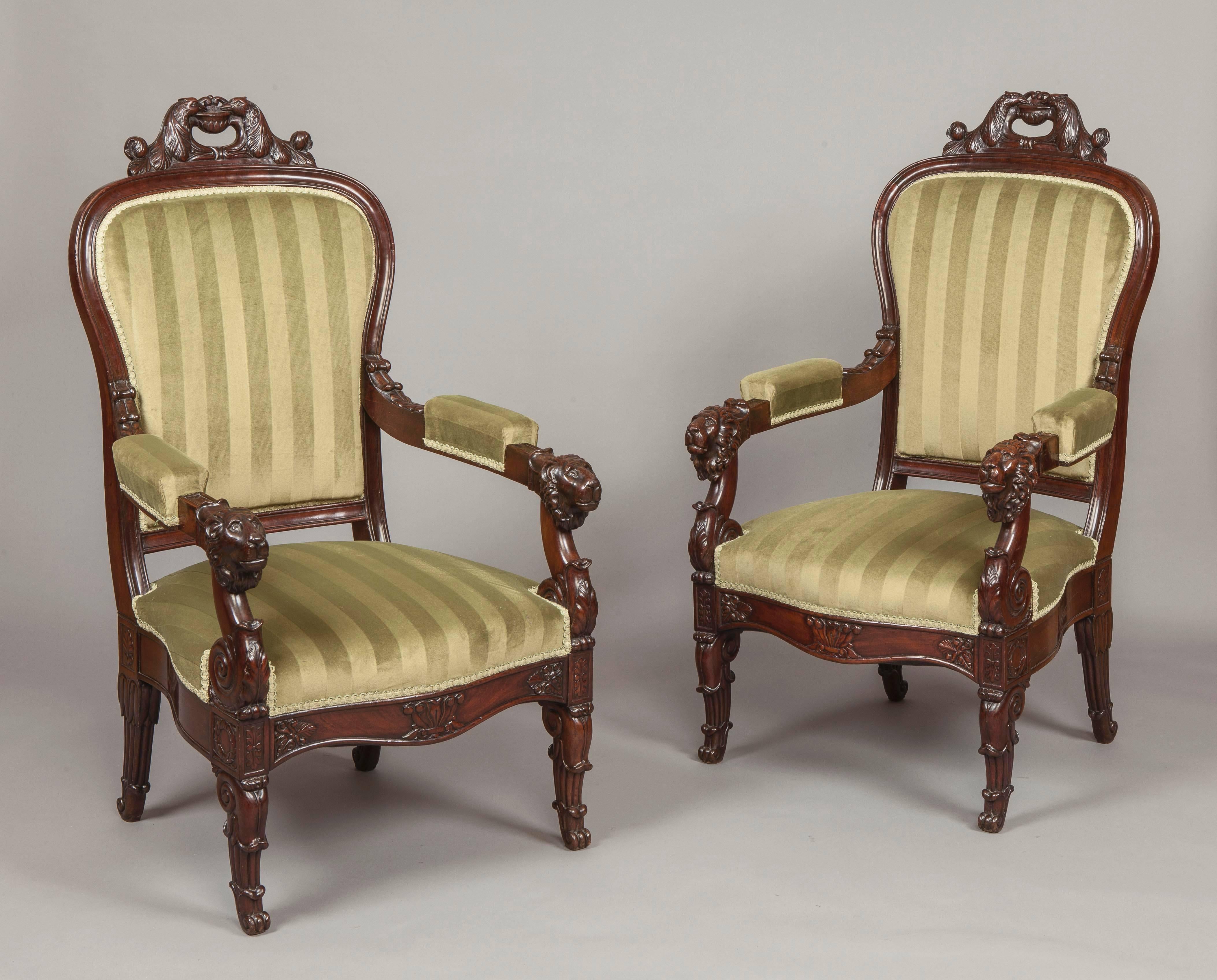 An Imposing Pair of Louis Philippe Fauteuils

Constructed in Honduras mahogany, standing on swept lappeted gentle 'S' shaped legs to the front, and sabre shaped to the rear, the padded arms, leaf carved, terminate in lions heads. The balloon form