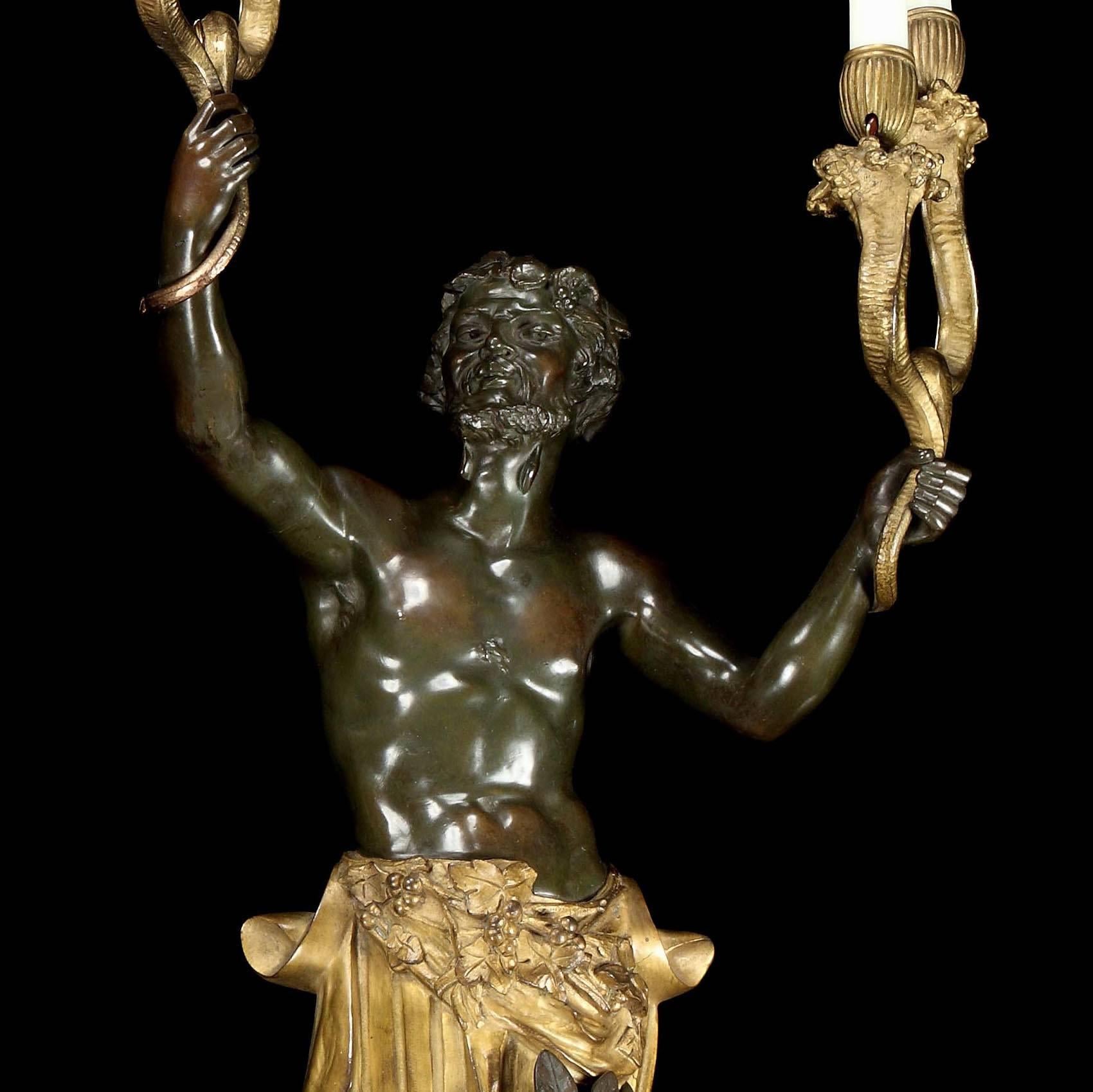 An important pair of wall appliques in the Louis XVth style

Cast in two color bronze, gold gilt and black patinated: herms of Bacchus and a Maenad, clad in foliate and berry dressed robes, terminating in pine cone finials, issue four sinuous candle