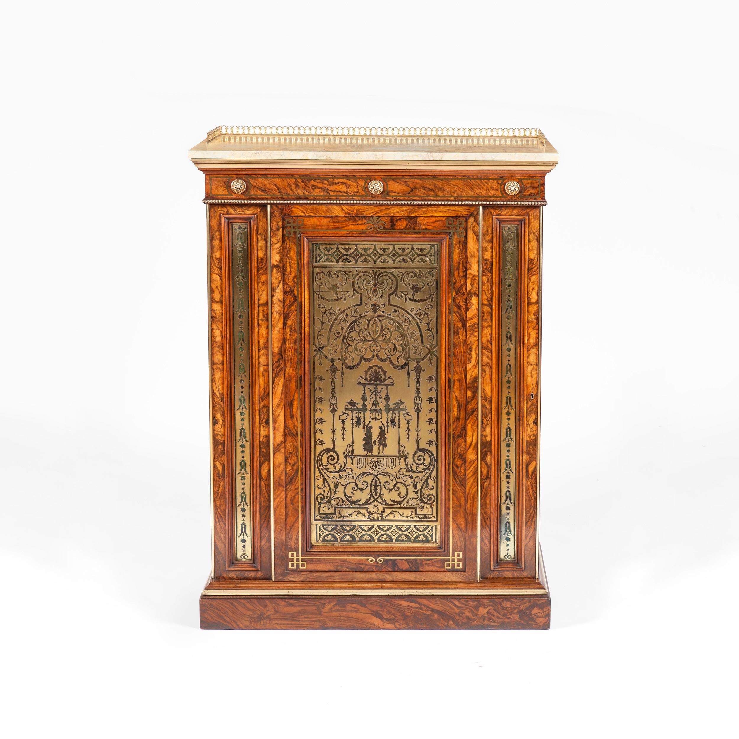 A William IV cabinet attributed to Town and Emmanuel

Constructed in a strongly grained olivewood and dressed with gold brass inlays and an etched and engraved brass panel; rising from a plinth base, the lockable single door having an inset panel in