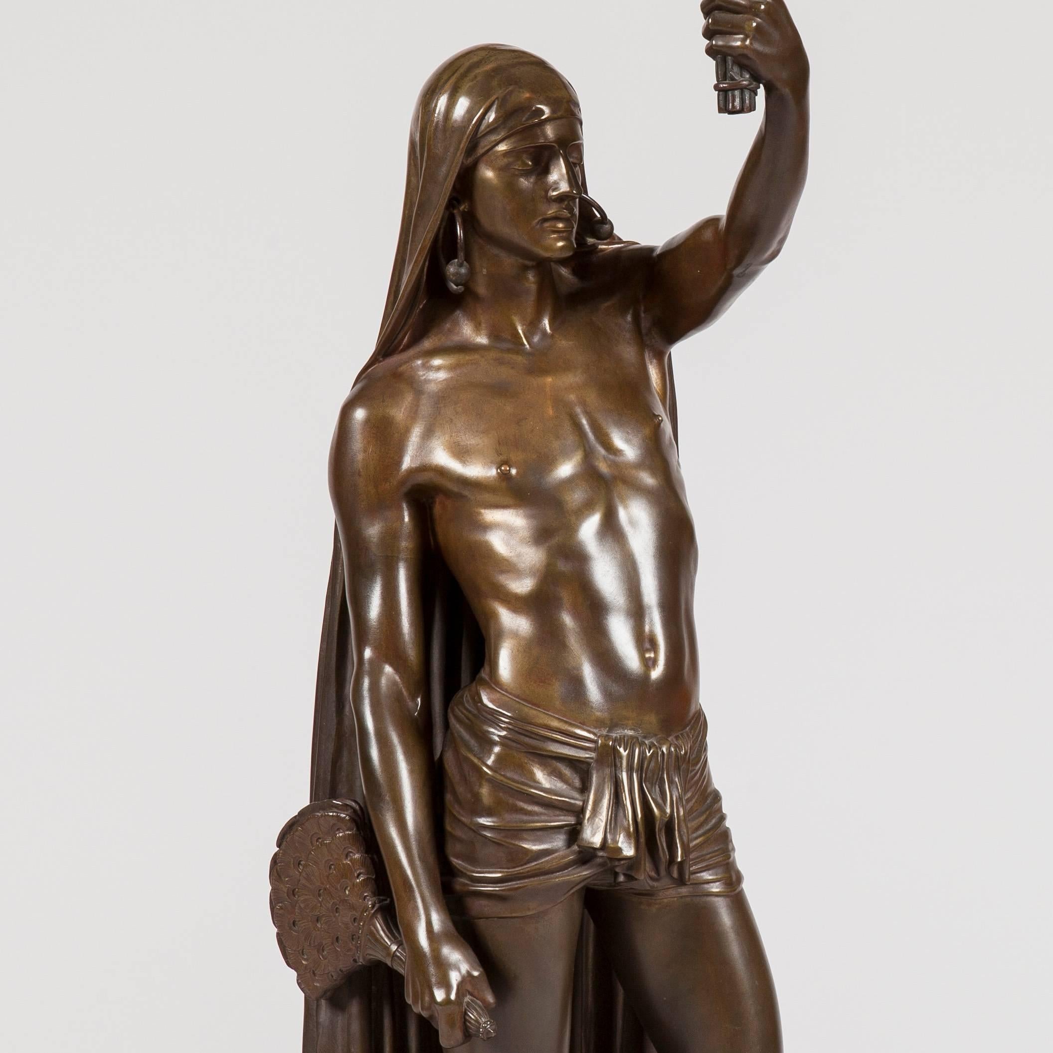 A well patinated bronze figure, representing an American Indian, wearing a draped headdress, robe and a pendant hooped earring. Signed to the plinth 'A.Tossaint 1850', and the foundry, 'Graux-Marly, Fat. de Bronze'
France, circa 1850

The