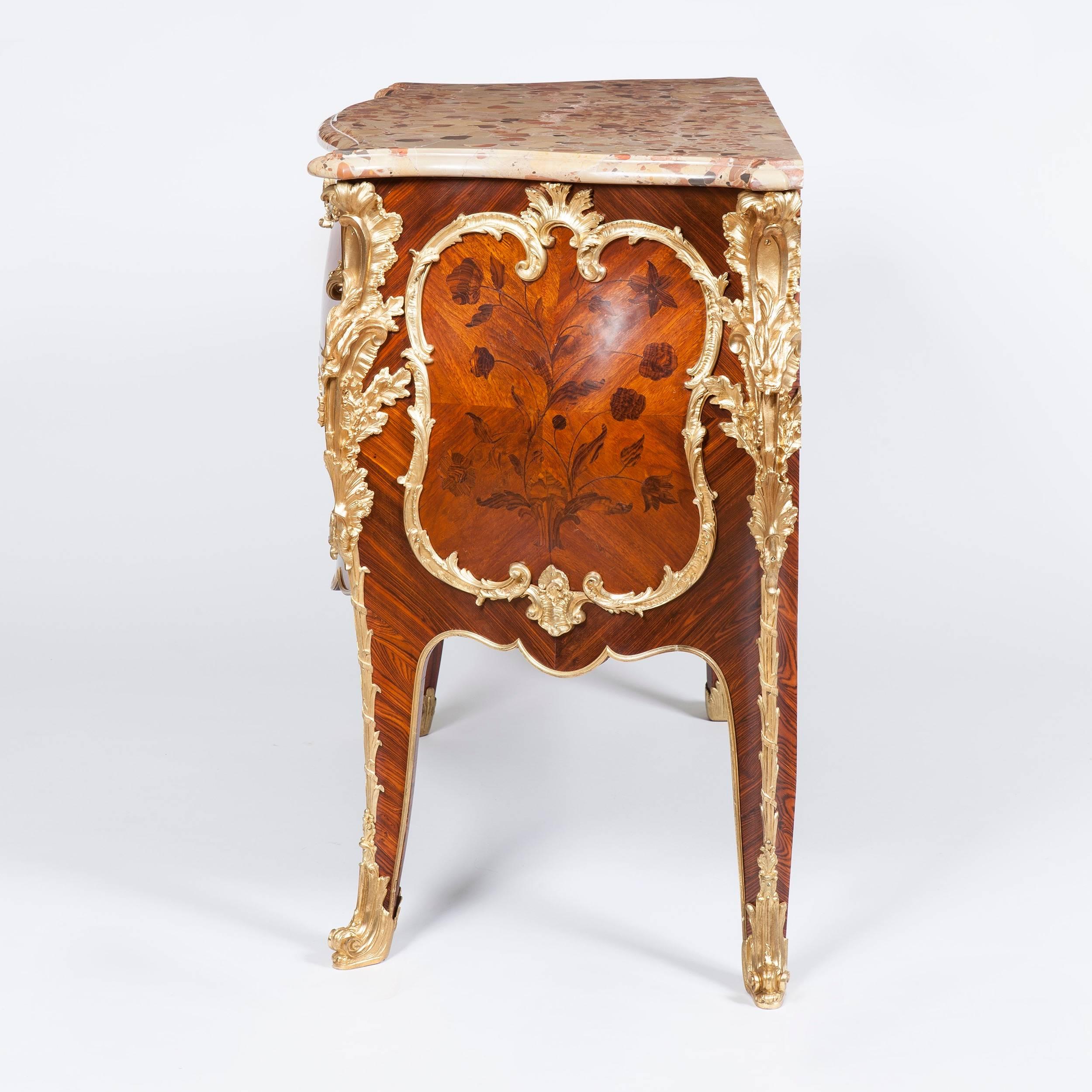 A fine commode in the Louis XV manner after a model by Jacques Dubois By Maison Rogié of Paris.

Constructed in book-matched kingwood veneers, inlaid with floral motifs, and richly decorated with fine ormolu mounts; of bombe serpentine form,