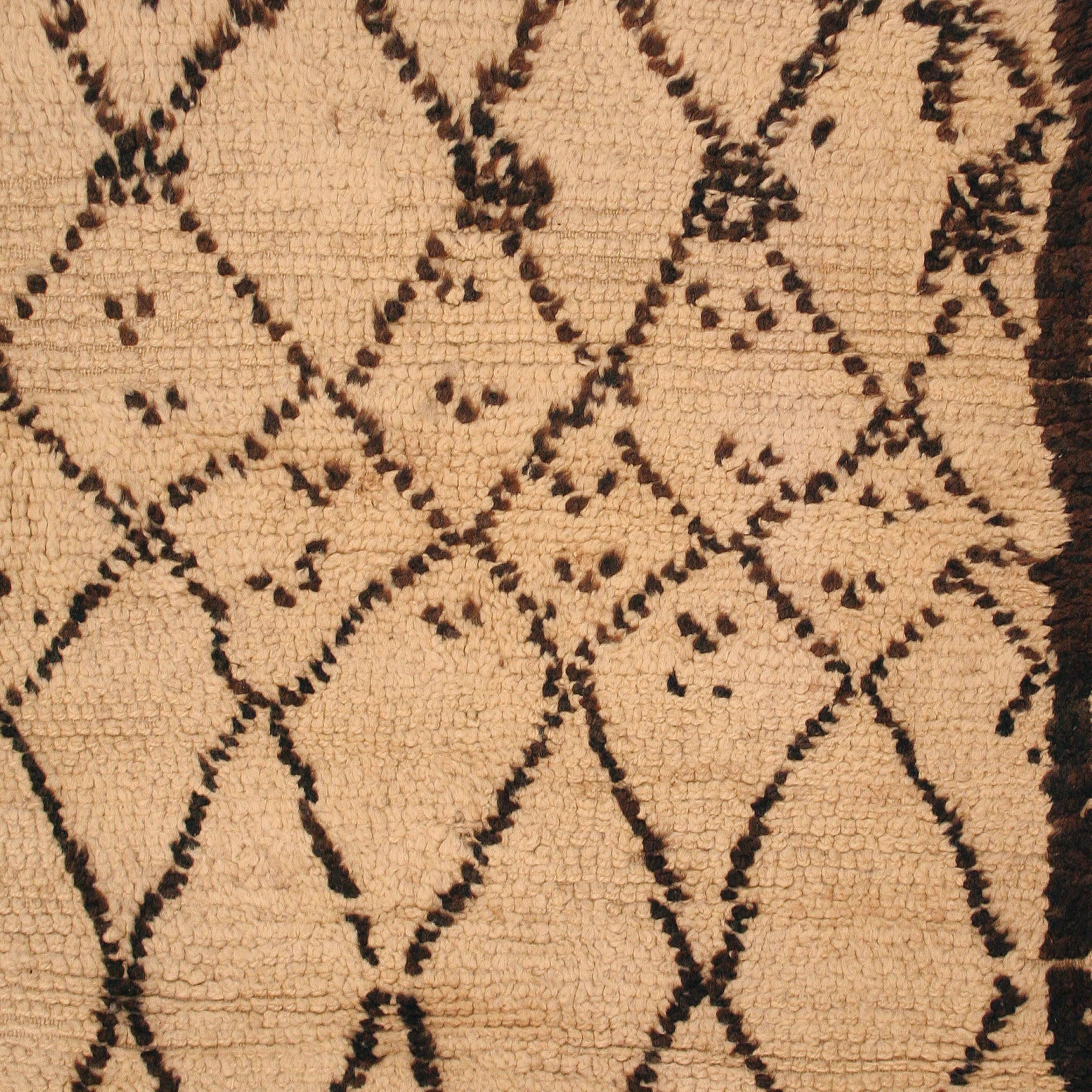 The carpets of the Beni Ouarain tribal confederacy differ from other Berber weavings in that they are woven exclusively with an ivory background and decorated with abstract geometric motifs of undyed natural wool. The high quality of the materials