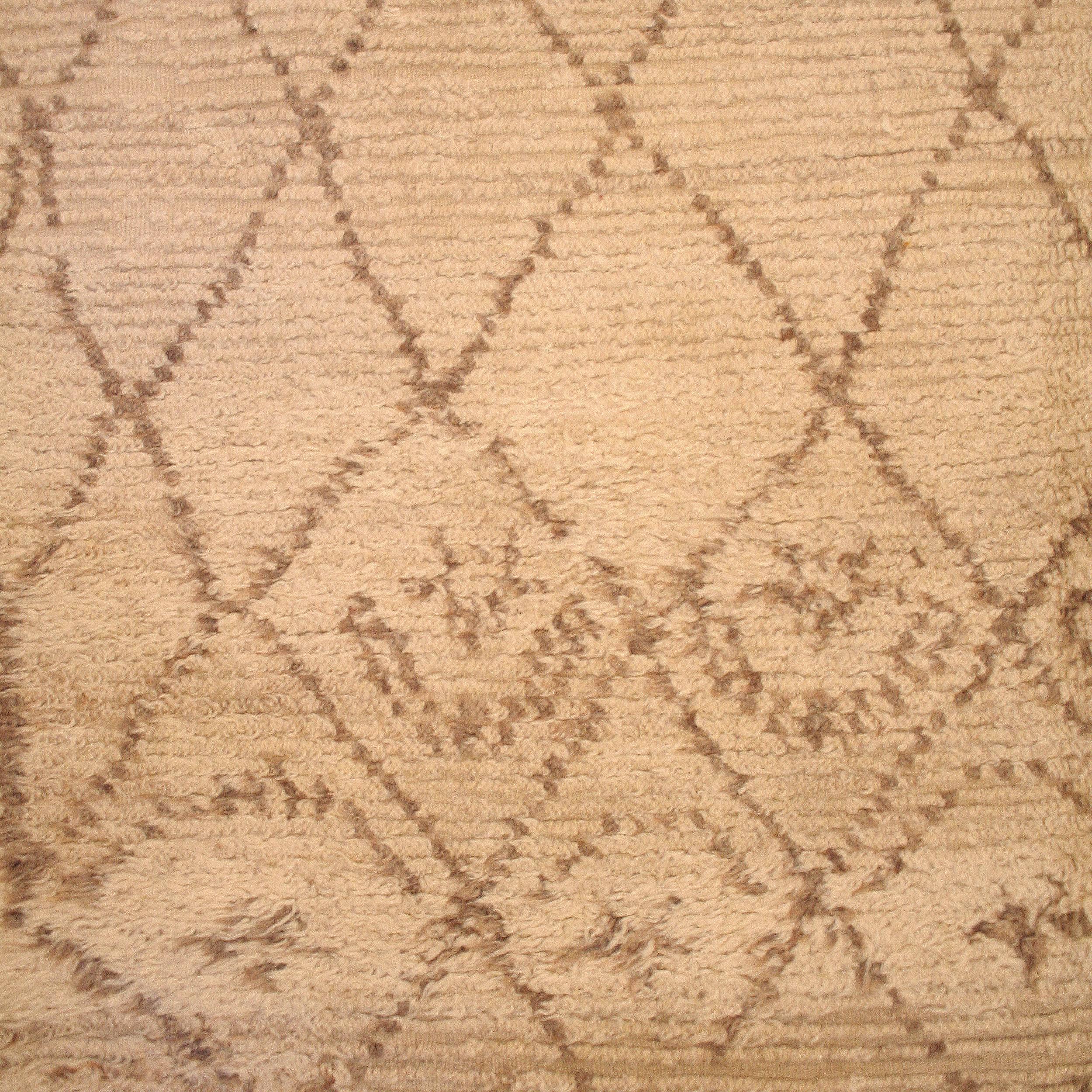 The carpets of the Beni Ouarain tribal confederacy, located in the Moroccan Middle Atlas, differ from other Berber weavings in that they are woven almost exclusively with an ivory background and decorated with abstract geometric motifs of undyed