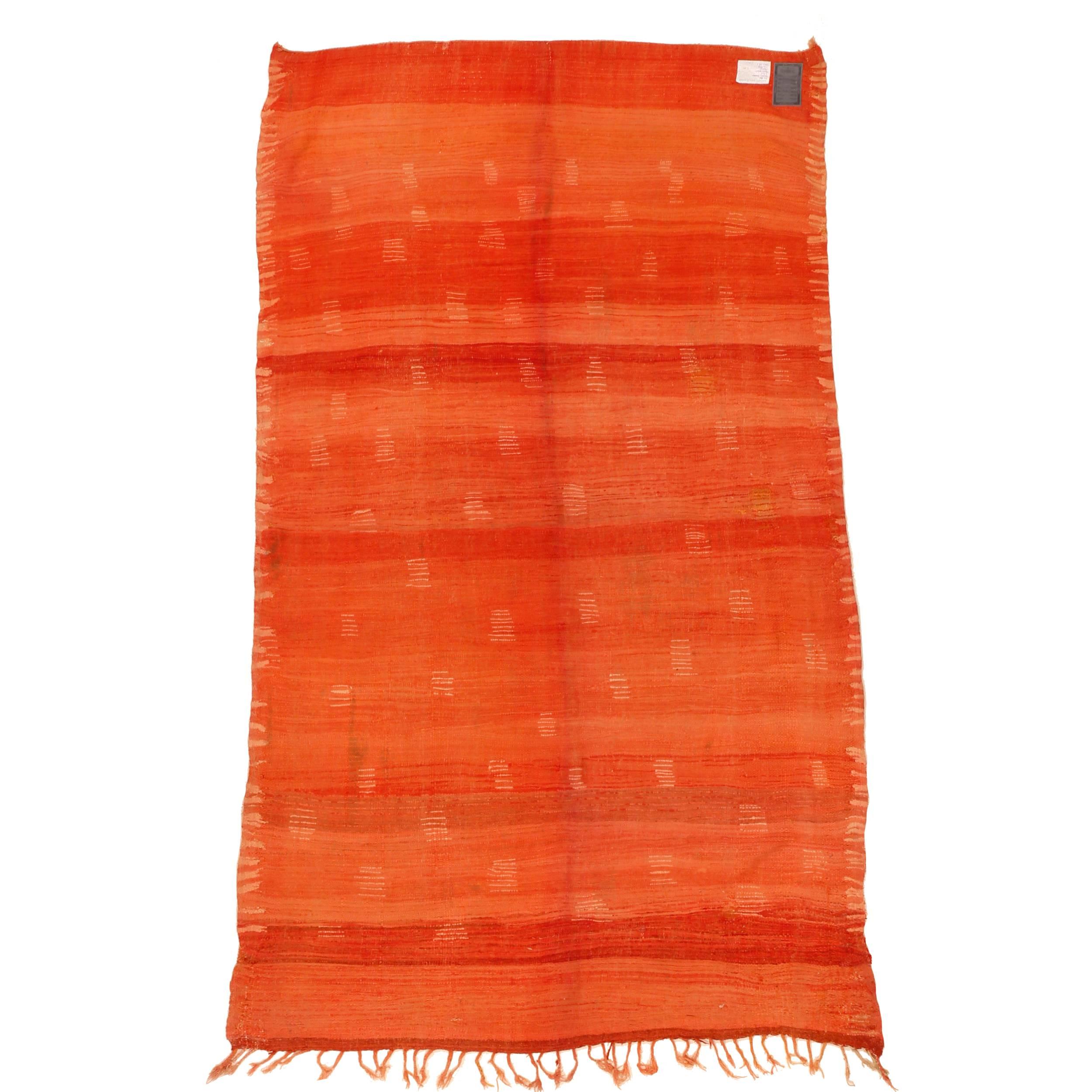 A magnificent example of Rehamna weaving, originating from the plains near Marrakesh, characterized by a fluid orange-red background punctuated by ivory dots in a manner that makes it look like a stylized animal pelt. Examples of this quality are