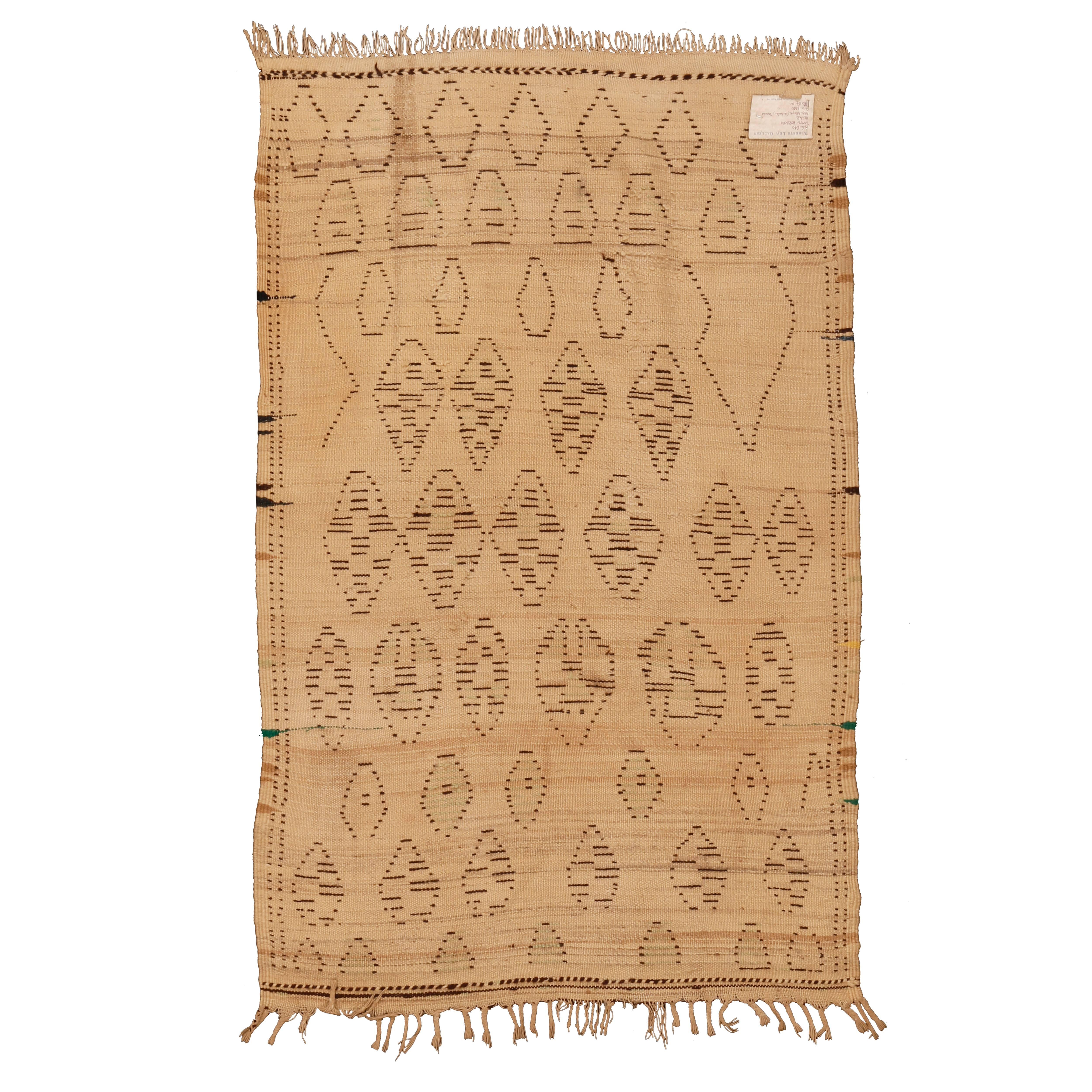 Woven with natural, undyed wool, this rug belongs to the earliest group of Azilal weavings and the first ones to appear on the market around the turn of the Millennium. Azilal rugs share some design features with some of the ivory ground weavings