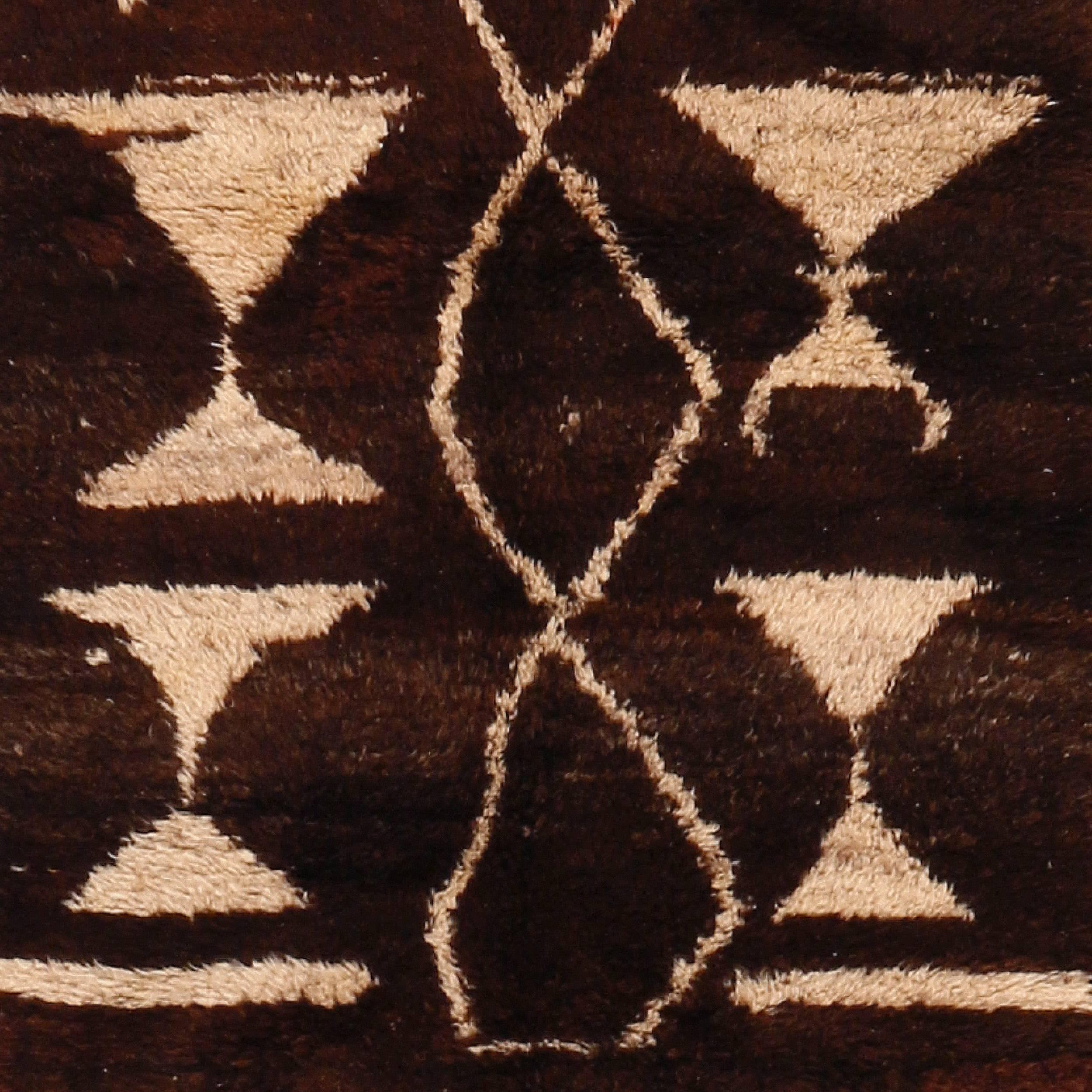 A highly unusual Tulu woven with natural, undyed mocha brown and ivory wool, resulting in a weaving with a markedly 'Art Deco' flavor. Tulu rugs display a primitive quality that makes them ideal complements to Modernist interiors. Their sparse