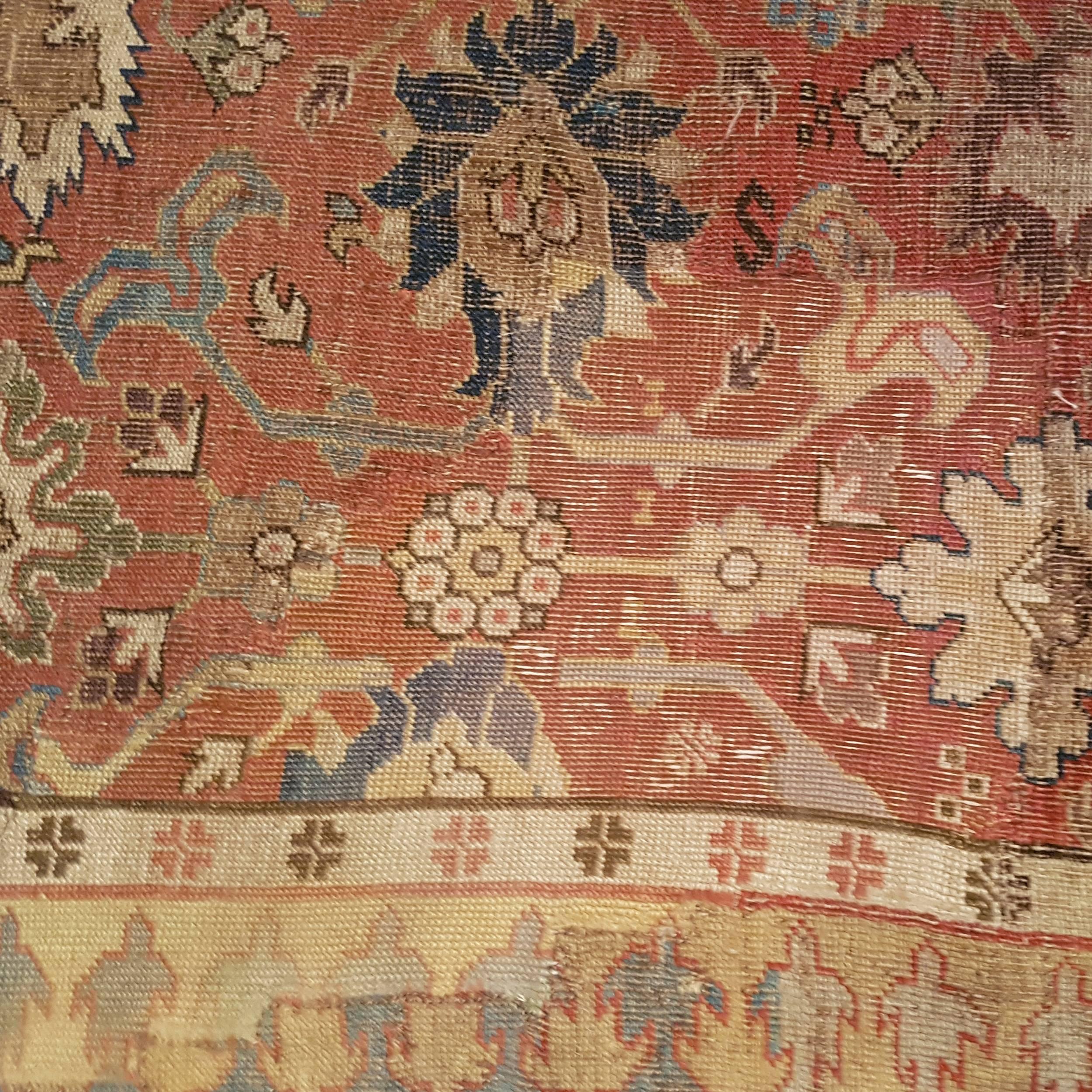 An extremely rare and early Caucasian carpet from present day Armenia ornate by an infinite repeat pattern of palmettes alternated to split-leaf arabesques known also as the 'harshang' design. This derives from 17th century Safavid 'Vase' carpets