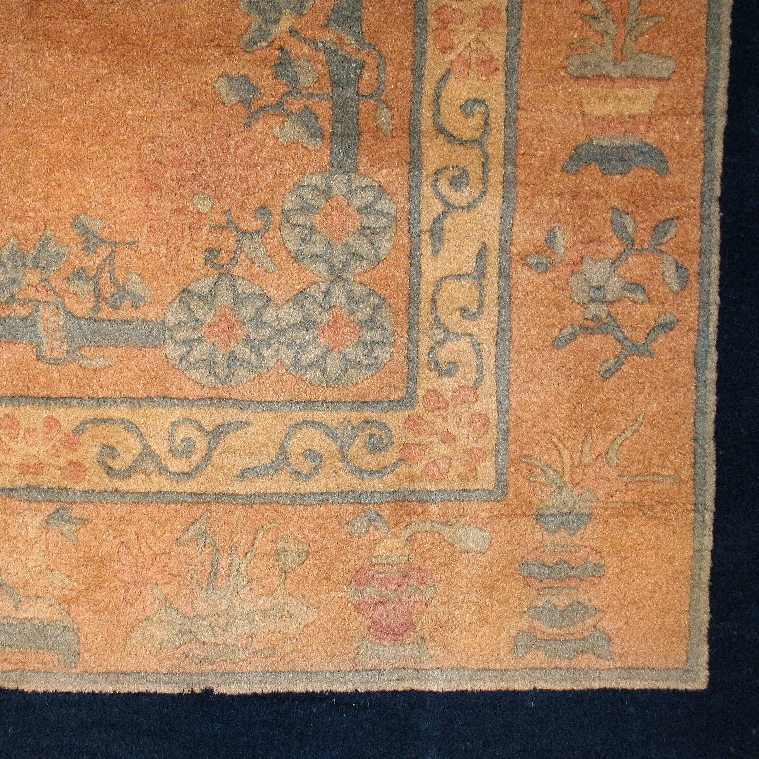 Carpets such as this one were woven in China during the Art Deco period in order to satisfy the demand in the West for decorative rugs designed in the Art Deco taste. Here the soft apricot open field is embellished with a central motif consisting of