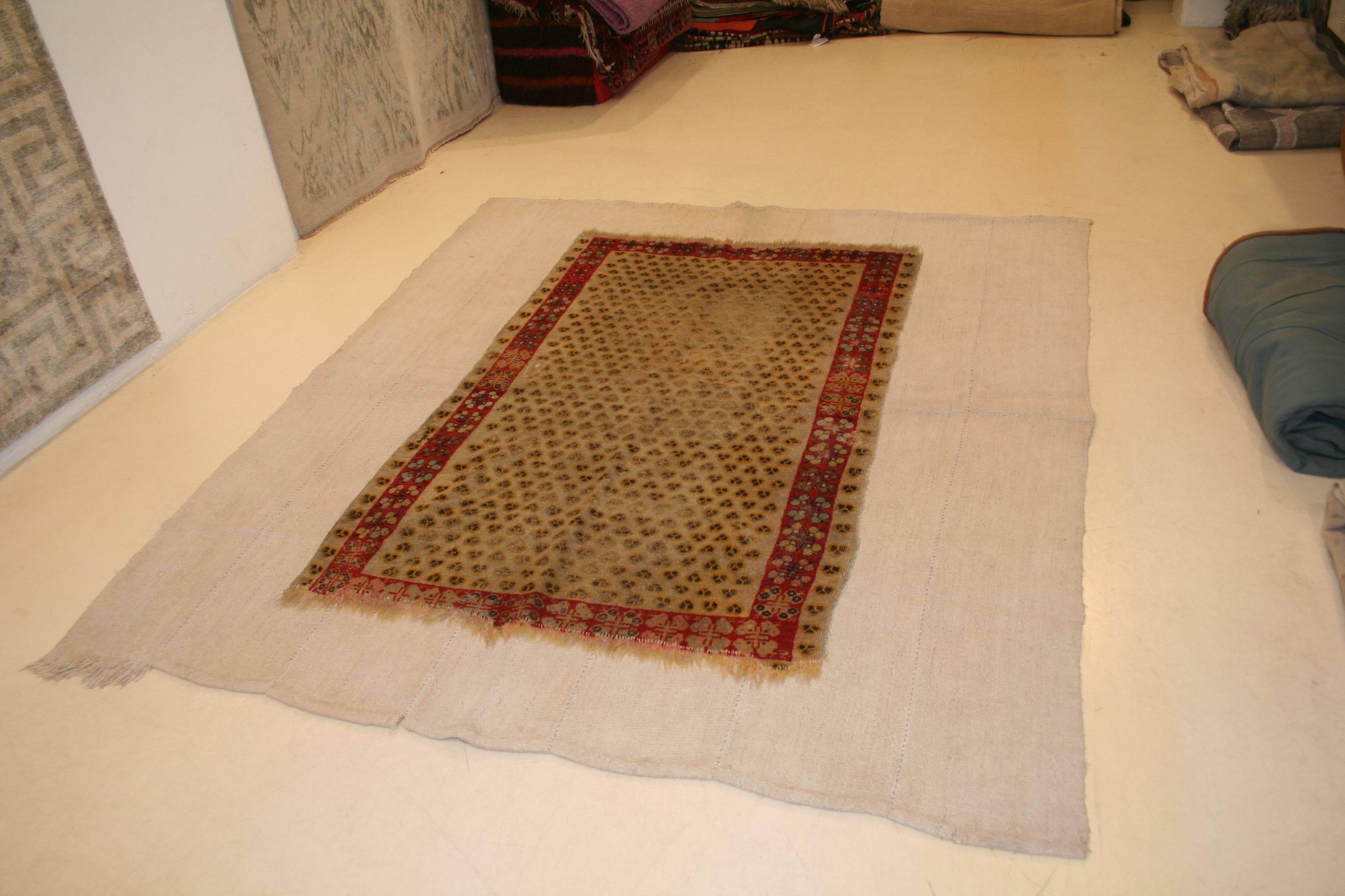 A fine antique Ghiordes rug distinguished by the rare pattern called 'Cintamani', originating from the Mongols and adopted as one of the favorite designs of the Ottoman court. The rug was stabilized 'as found' (unrestored) by hand stitching it onto