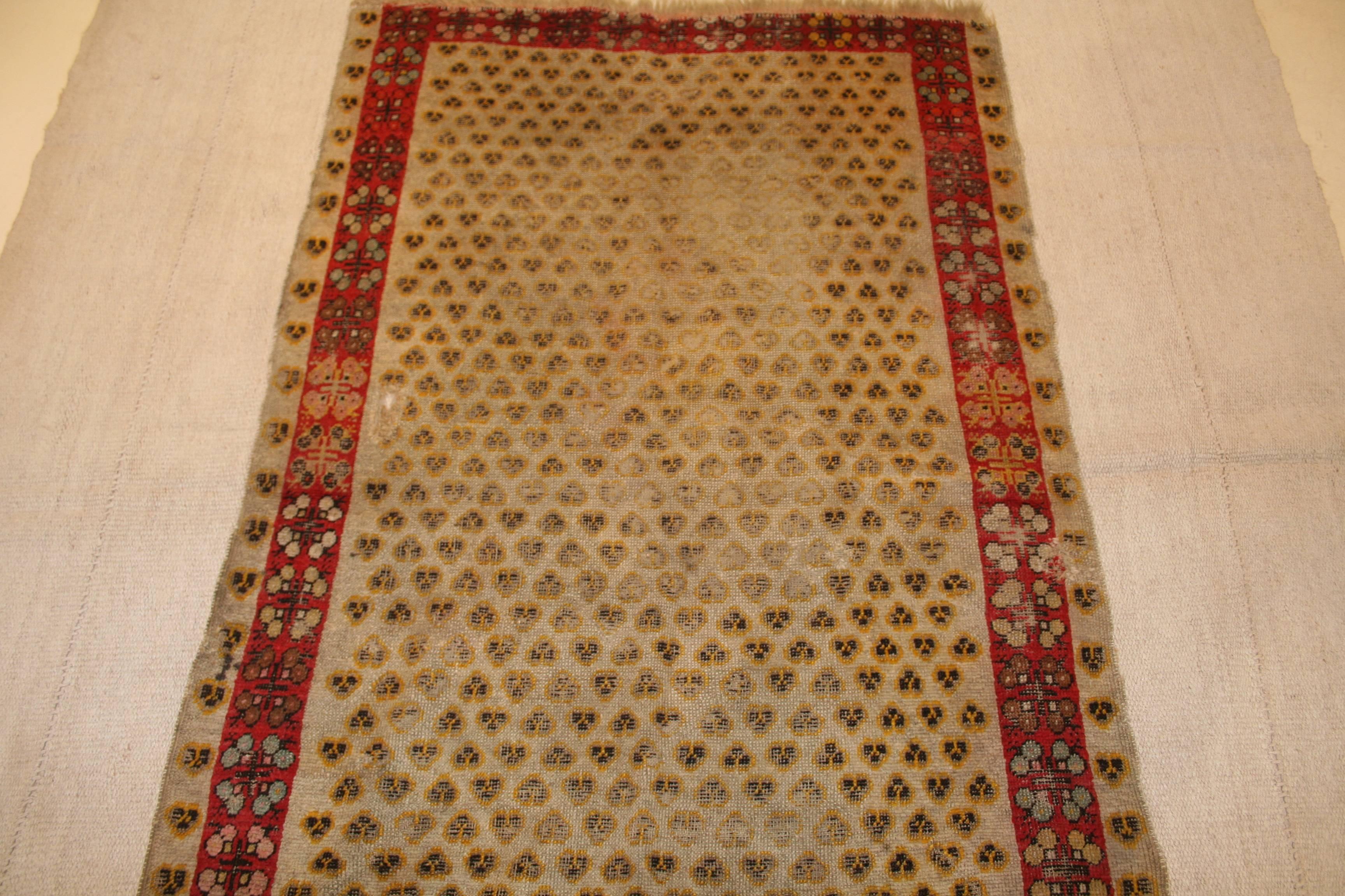 Turkish Distressed Antique Ghiordes Rug with Cintamani Pattern