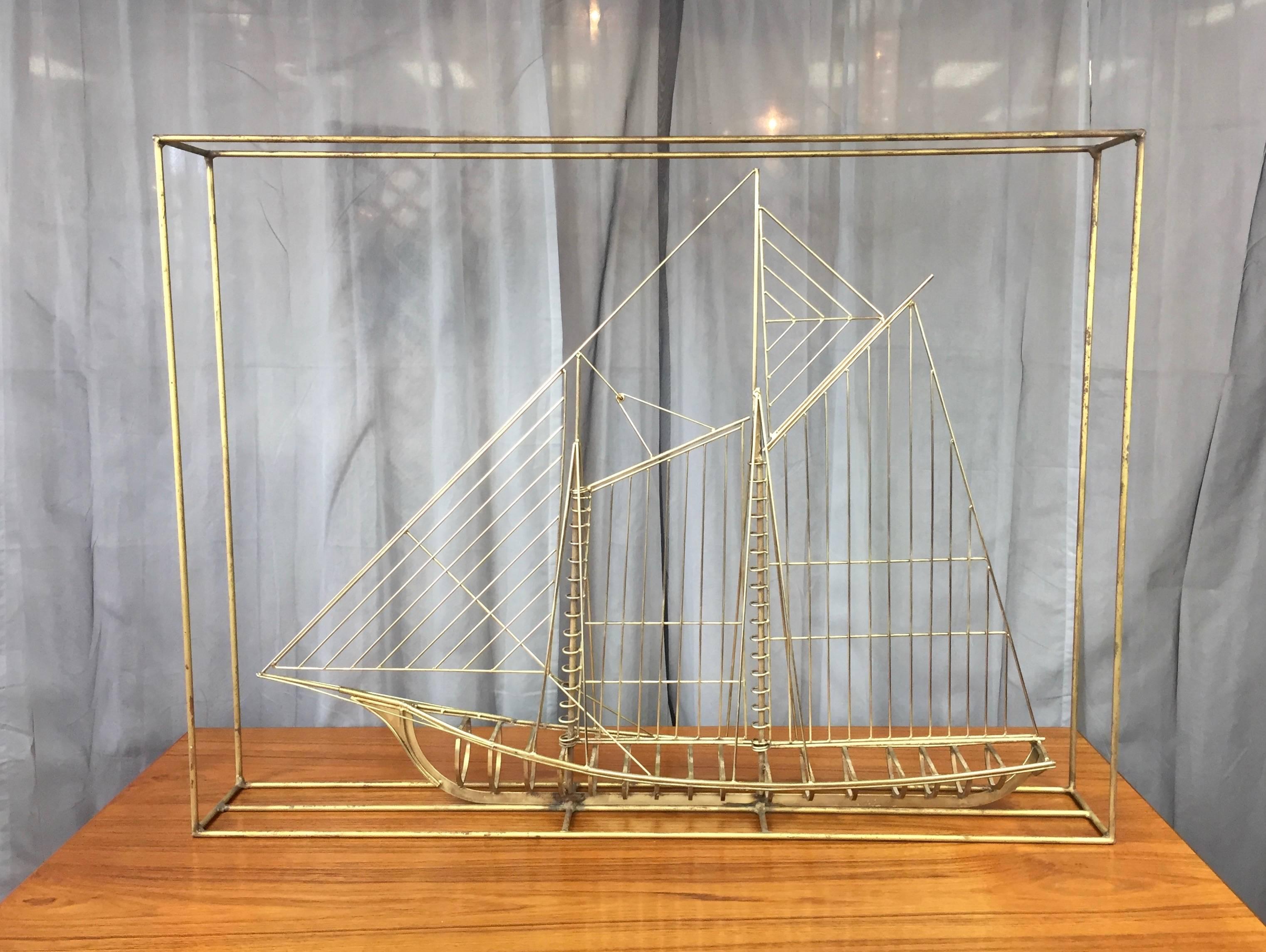 A monumental free-standing metal ship sculpture with brass-colored finish by Curtis Jeré, signed.

Crafted out of shaped and welded steel rods, it resembles an architectural line drawing of a clipper ship rendered in 3-D. Features a rarely seen