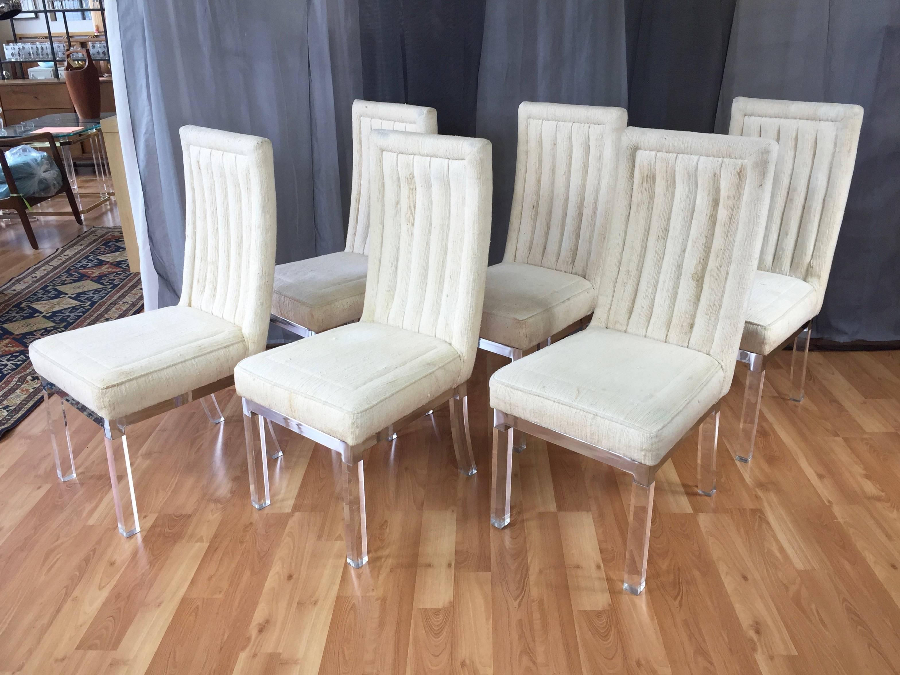 
Four Hollywood glam dining chairs with Lucite legs, polished nickel plate bases and upholstered high back seats by Charles Hollis Jones.

Crystal clear legs and mirror-finish base give each chair the enchanted appearance of floating in mid-air.