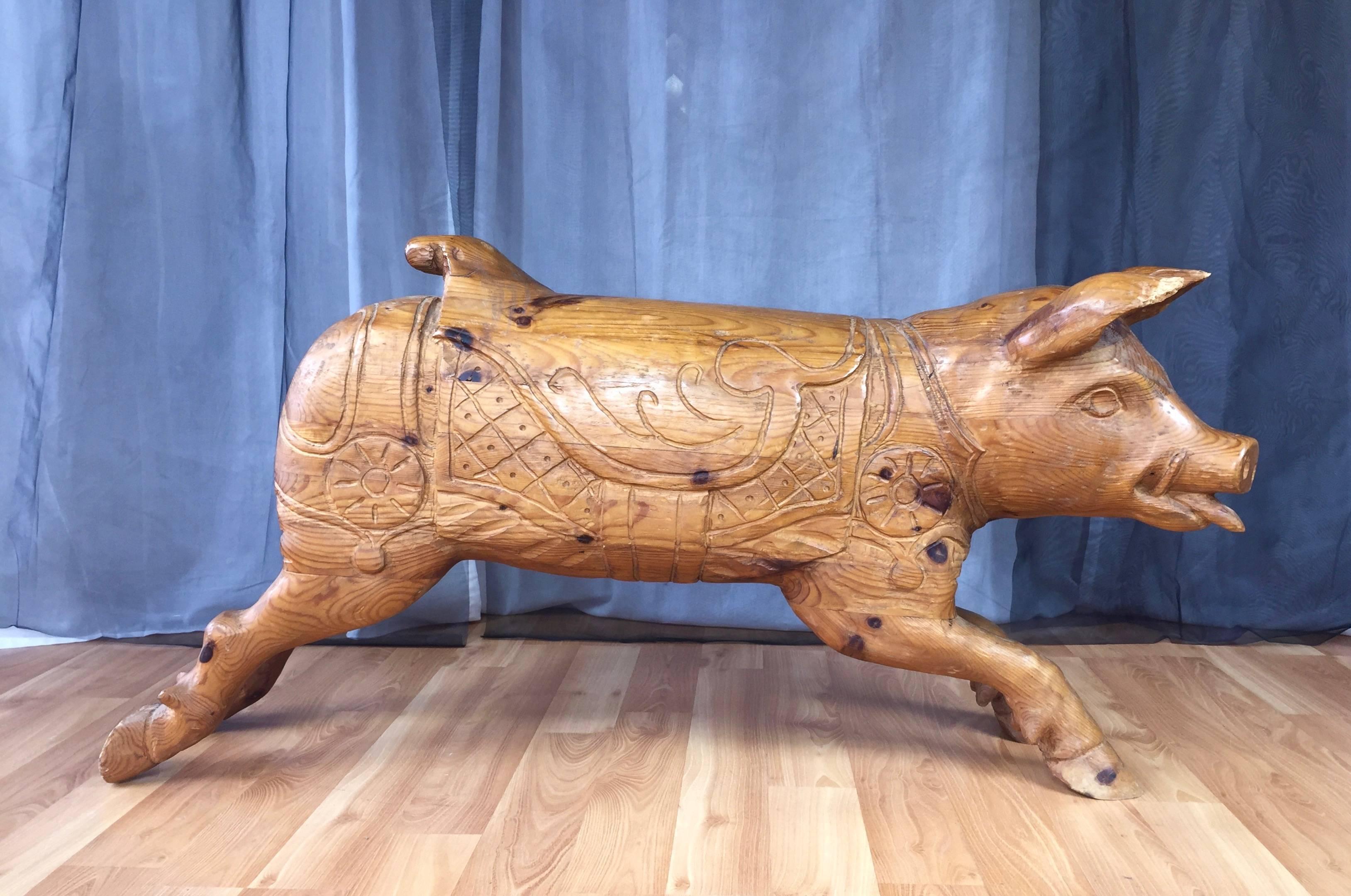 A very large hand-carved solid wood boar or pig sculpture believed to have originally been destined for a carousel or merry-go-round.

Though apparently abandoned just before completion, this happy and handsome guy is full of character, from his