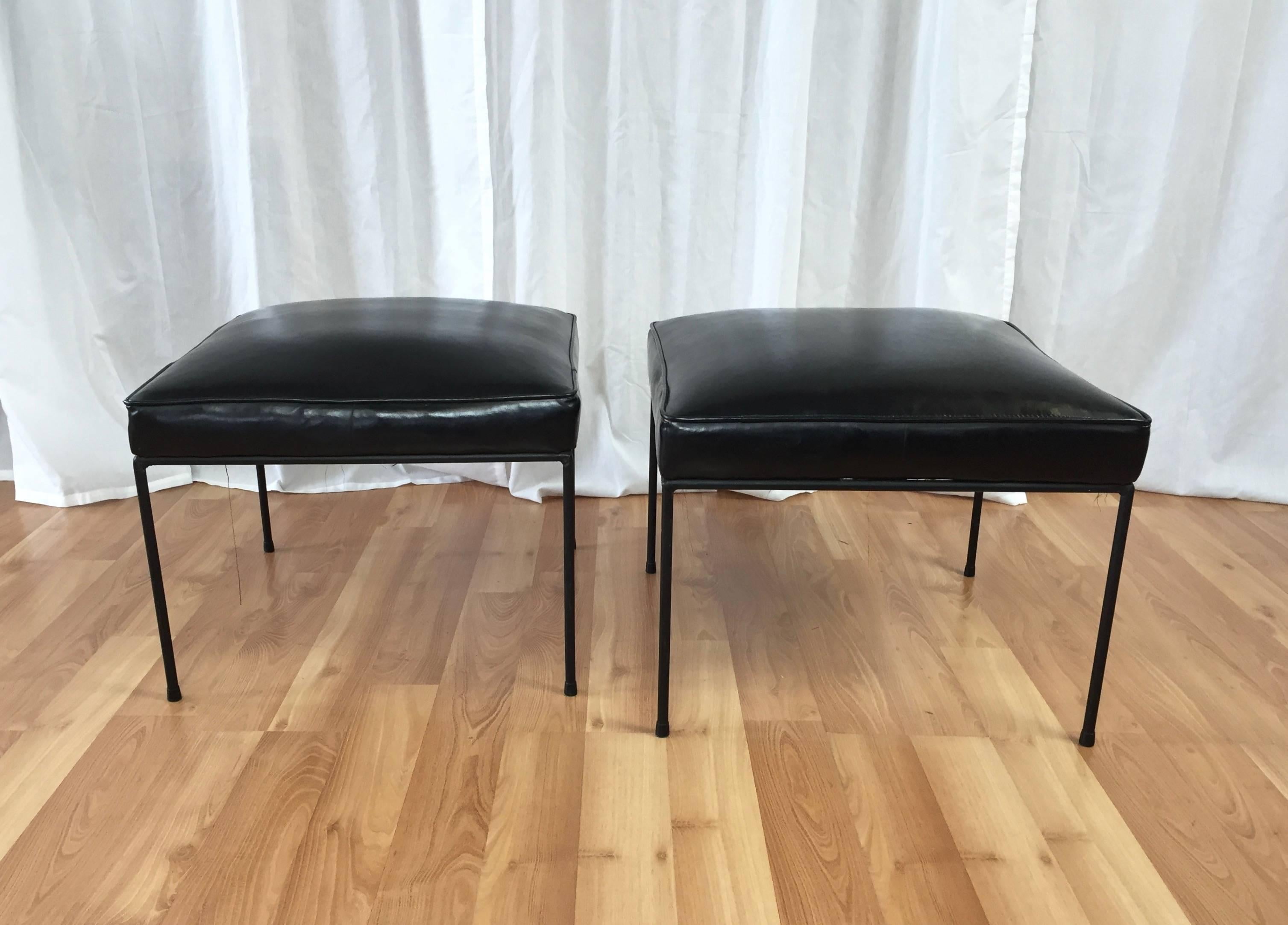 A pair of black wrought iron and faux leather No. 1305 “All ‘Round Square” stools or ottomans by Paul McCobb from the Planner Group line for Winchendon Furniture.

Black enameled iron frame with original rubber feet. Supple original faux leather