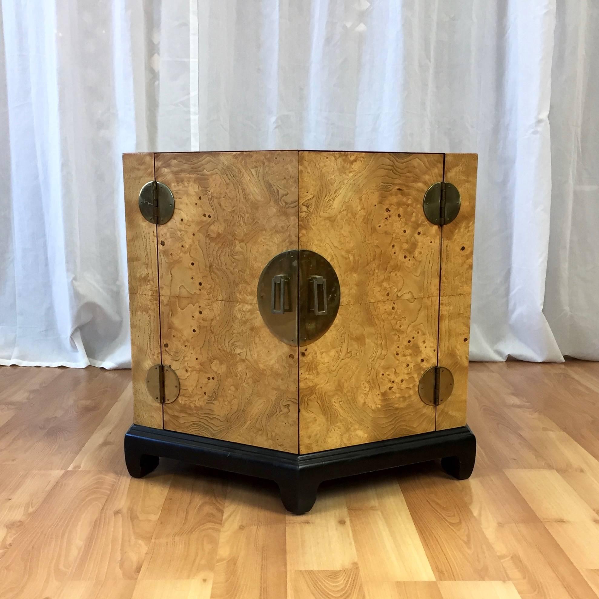 An Asian-influenced hexagonal two-door burl wood end table or nightstand cabinet attributed to Henredon.

Distinguished by dazzling book matched Carpathian elm burl veneer with an extremely lively figure that evokes desert landscapes, topographic