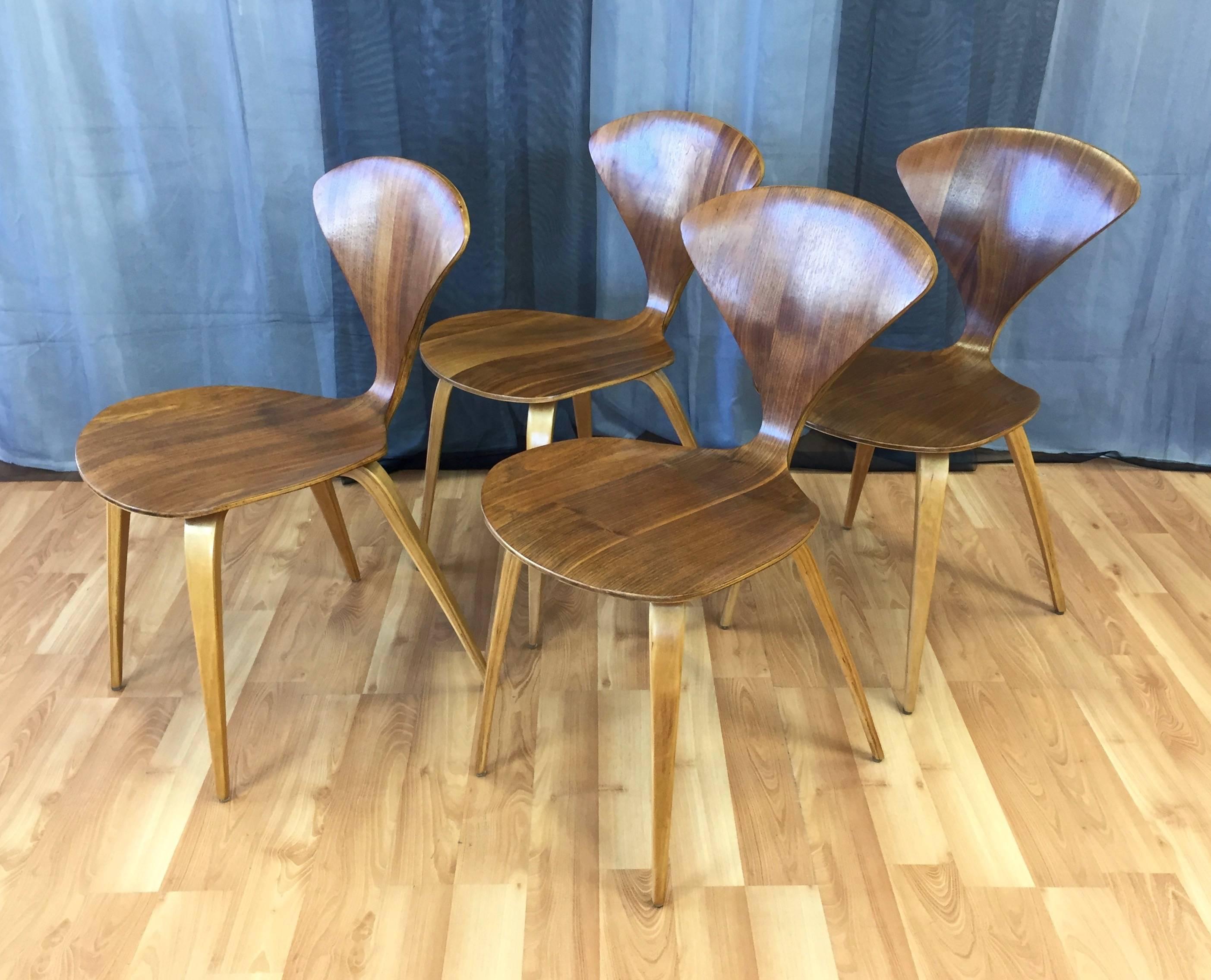 A four-piece set of vintage walnut and birch bentwood side or dining chairs by Norman Cherner for Plycraft.

American Mid-Century Modern design and craftsmanship in its most fluid and unfussy form. Walnut veneer over laminated plywood that varies