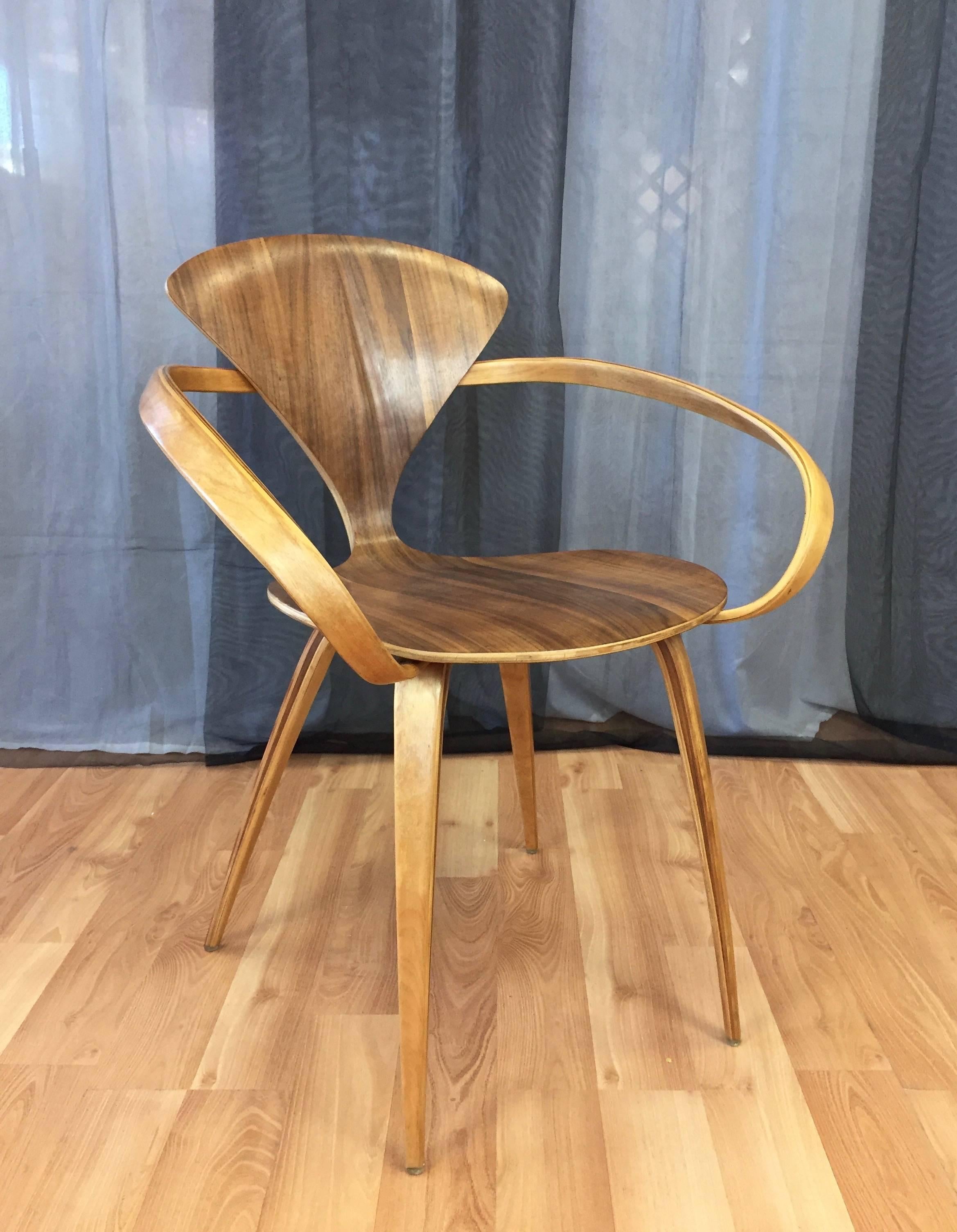 A vintage walnut and birch bentwood armchair or captain’s chair by Norman Cherner for Plycraft.

A Mid-Century Modern design icon commonly referred to as the “Pretzel” chair, its fluid form features walnut veneer laminated plywood that varies in