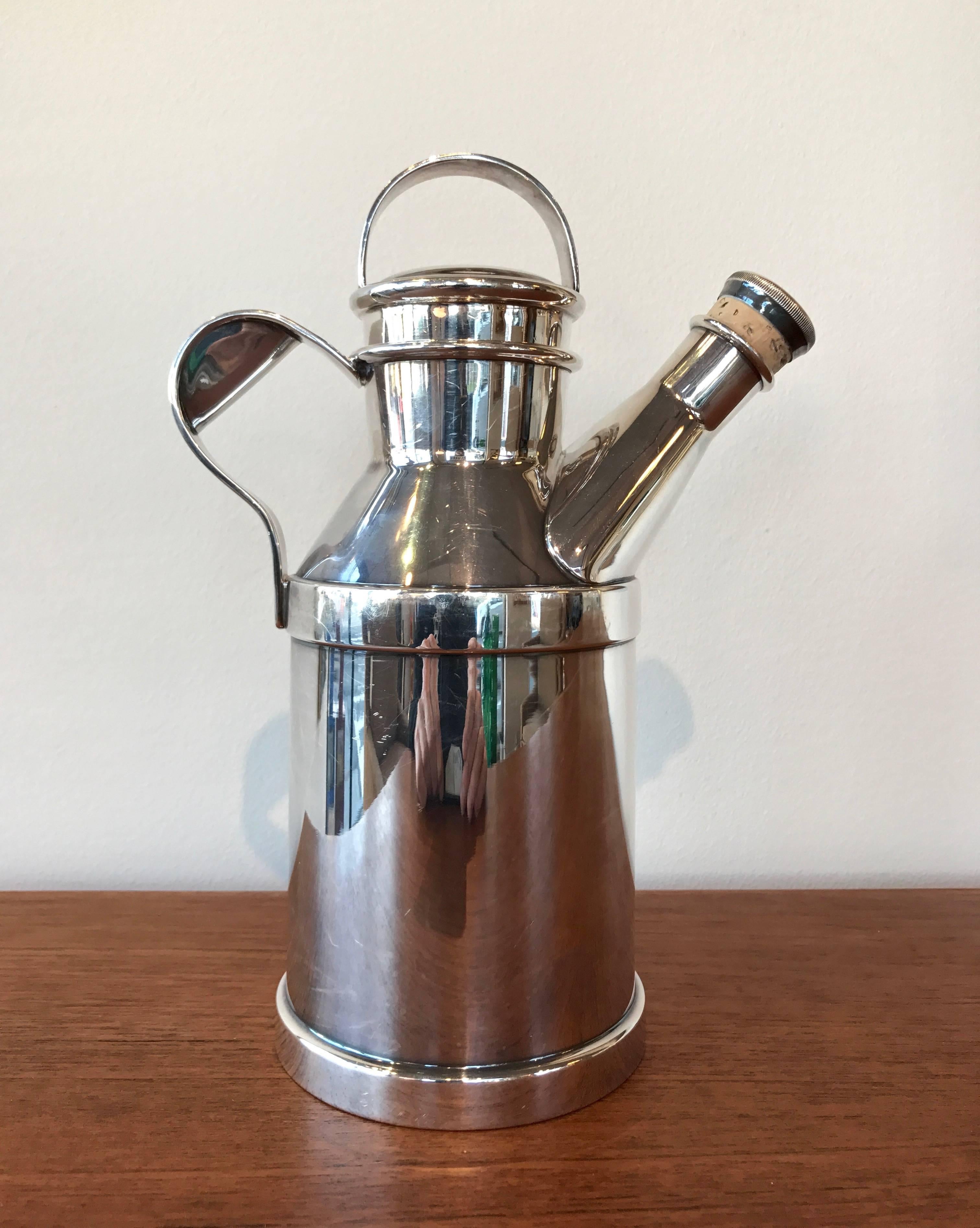 A 32 oz. silver plate “Milk Jug” cocktail Shaker by Reed & Barton. This highly sought-after Shaker features a delightful design reminiscent of a milk jug or gas or oil can. Features two stoppers, the smaller of which retains its original cork in
