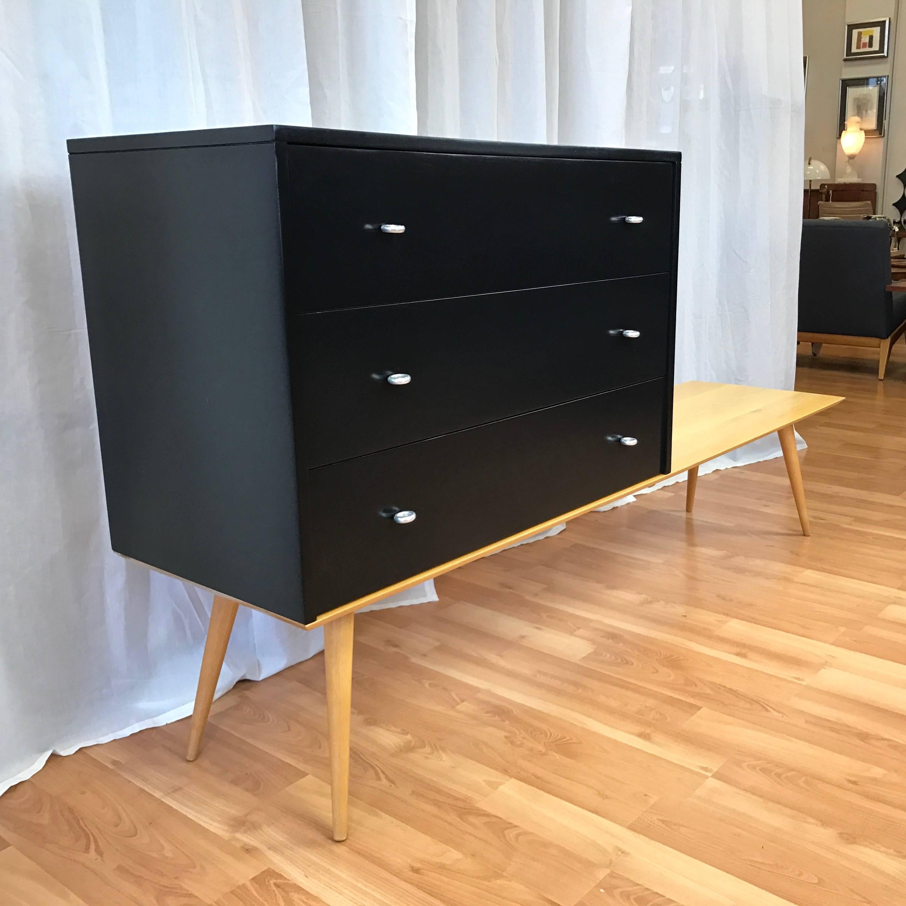 A “Planner Group” three-drawer chest by Paul McCobb for Winchendon Furniture with custom bench done in the manner of.

Chest or dresser features satin black lacquer finish and original aluminium ring pulls. Sits on a six-foot long well-made maple