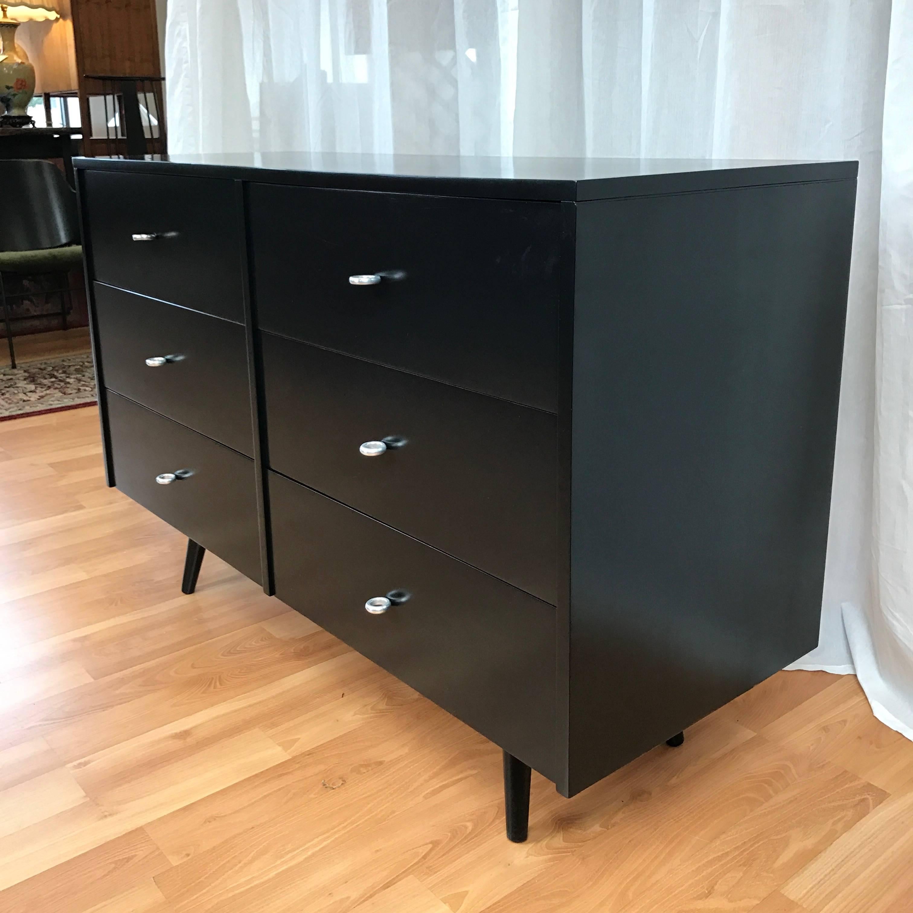 A “Planner Group” six-drawer dresser by Paul McCobb for Winchendon Furniture.

Maple dresser features satin black lacquer finish and retains its original aluminum ring pulls. Branded with maker’s mark on side of drawer. Fully restored and an