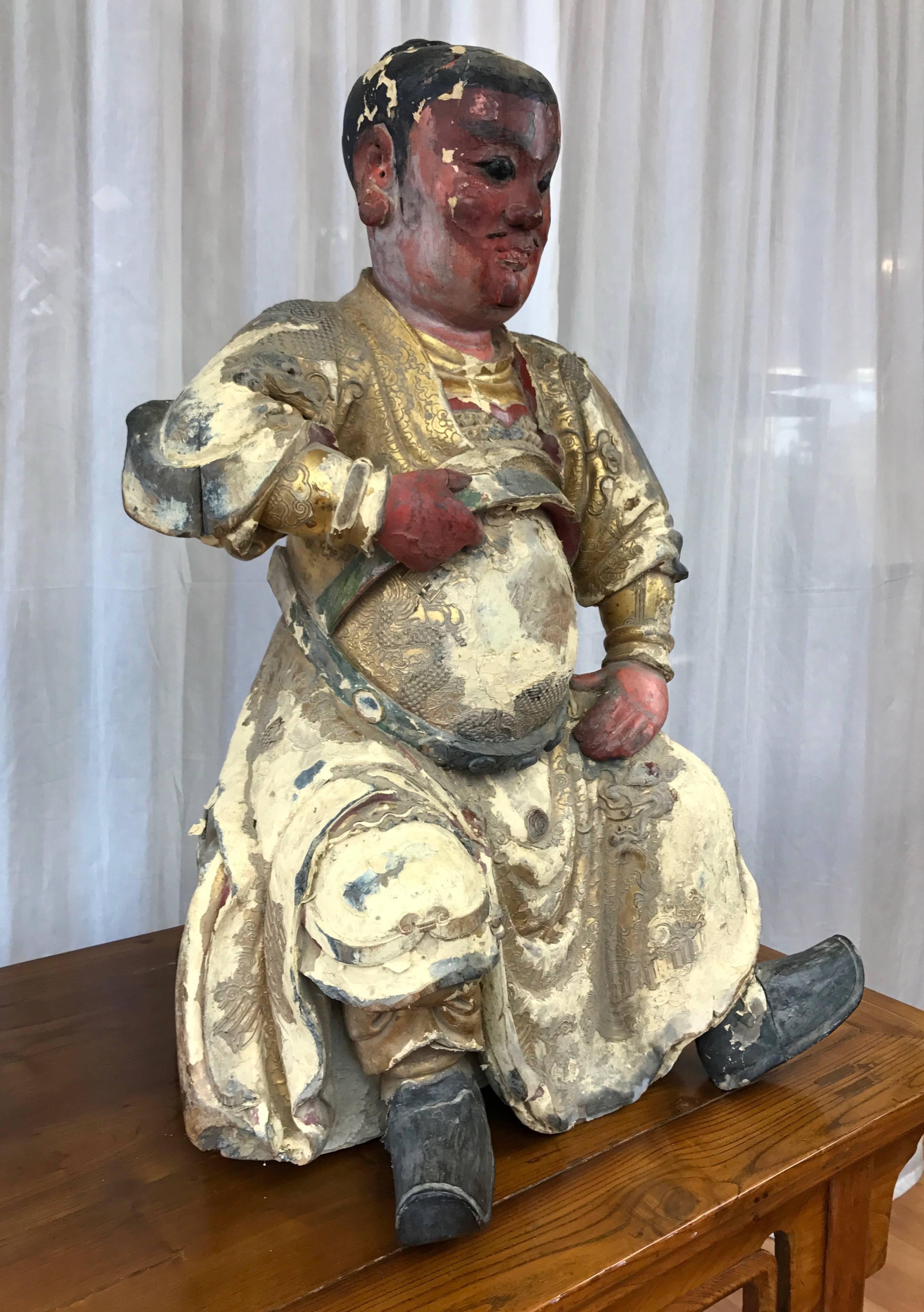 An extraordinary and imposing Qing dynasty carved and painted wood temple figure depicting Chinese god of war Guandi, from the early 18th century.

Layers of highly detailed textures, patterns, and decorations cover an intricately carved figure