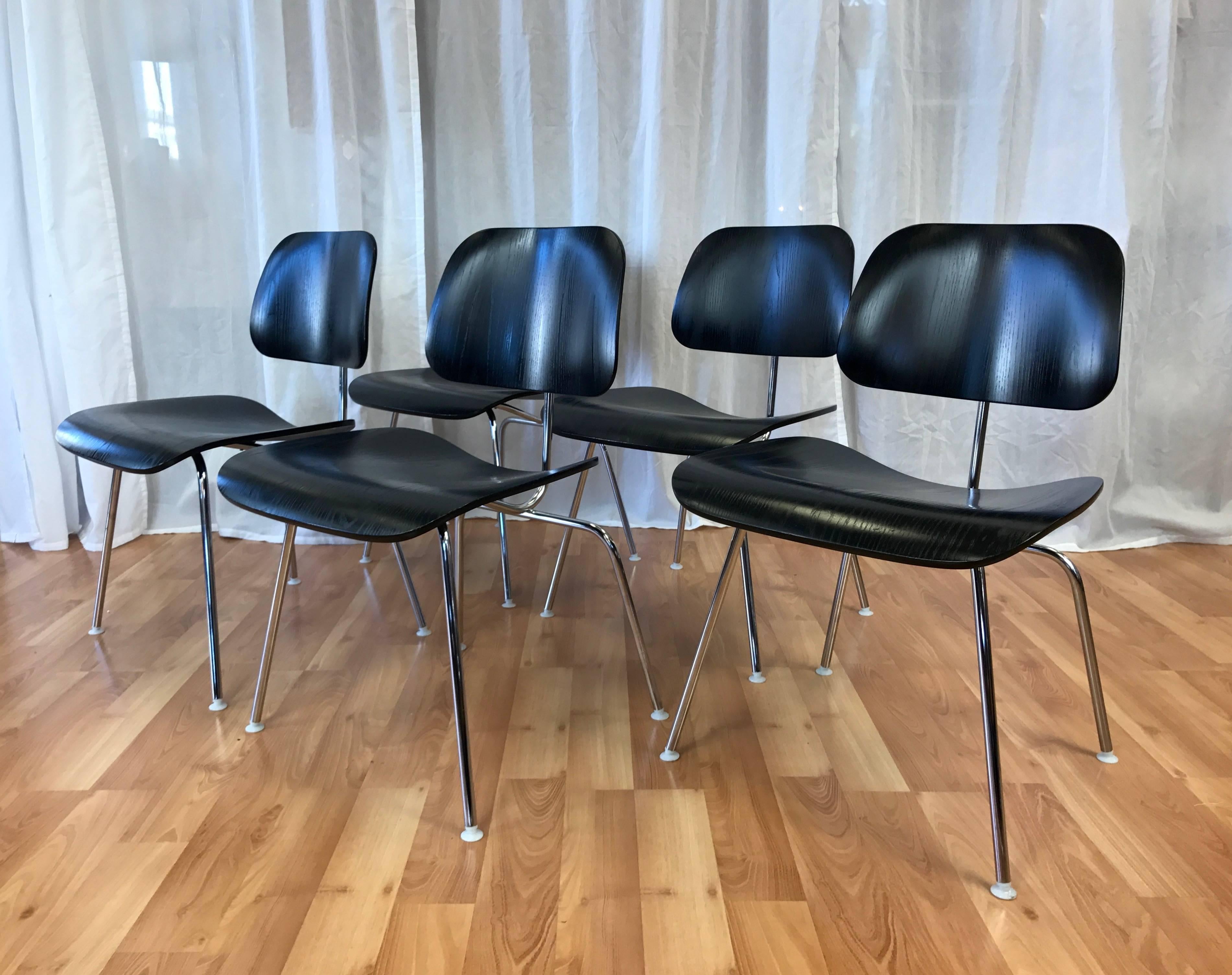 Newer production DCM chairs in ebony by Charles & Ray Eames for Herman Miller.

circa 2006 examples of a Mid-Century Modern design icon introduced in 1946, each in great condition over all. Molded plywood seat and back in ash veneer with ebony