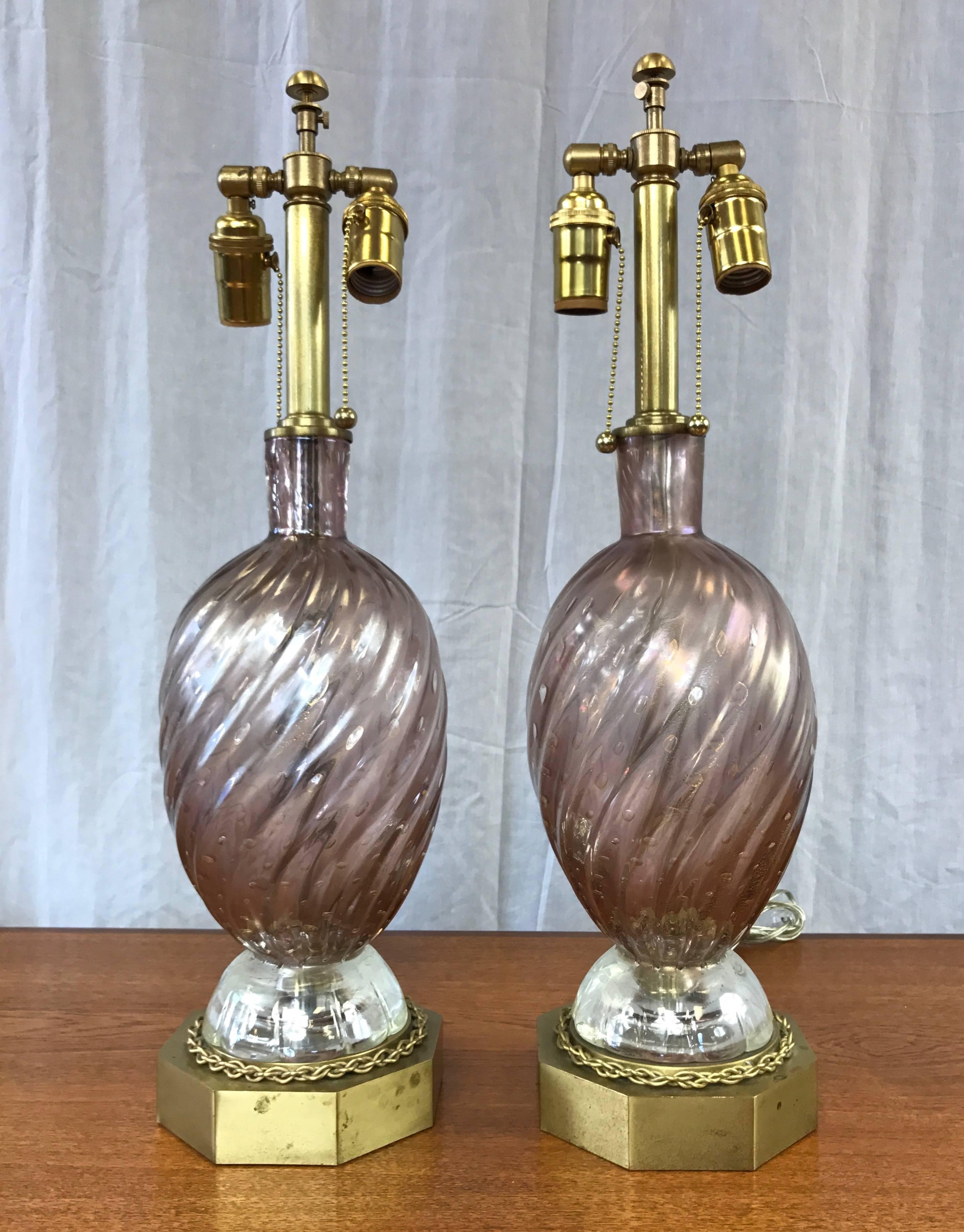 An entrancing pair of vintage Venetian-style glass and brass table lamps by venerable Murano glassworks company Barovier e Toso.

Beautiful handblown bullicante glass body is pale amethyst with dusty rose undertones. It’s enhanced by a shimmering