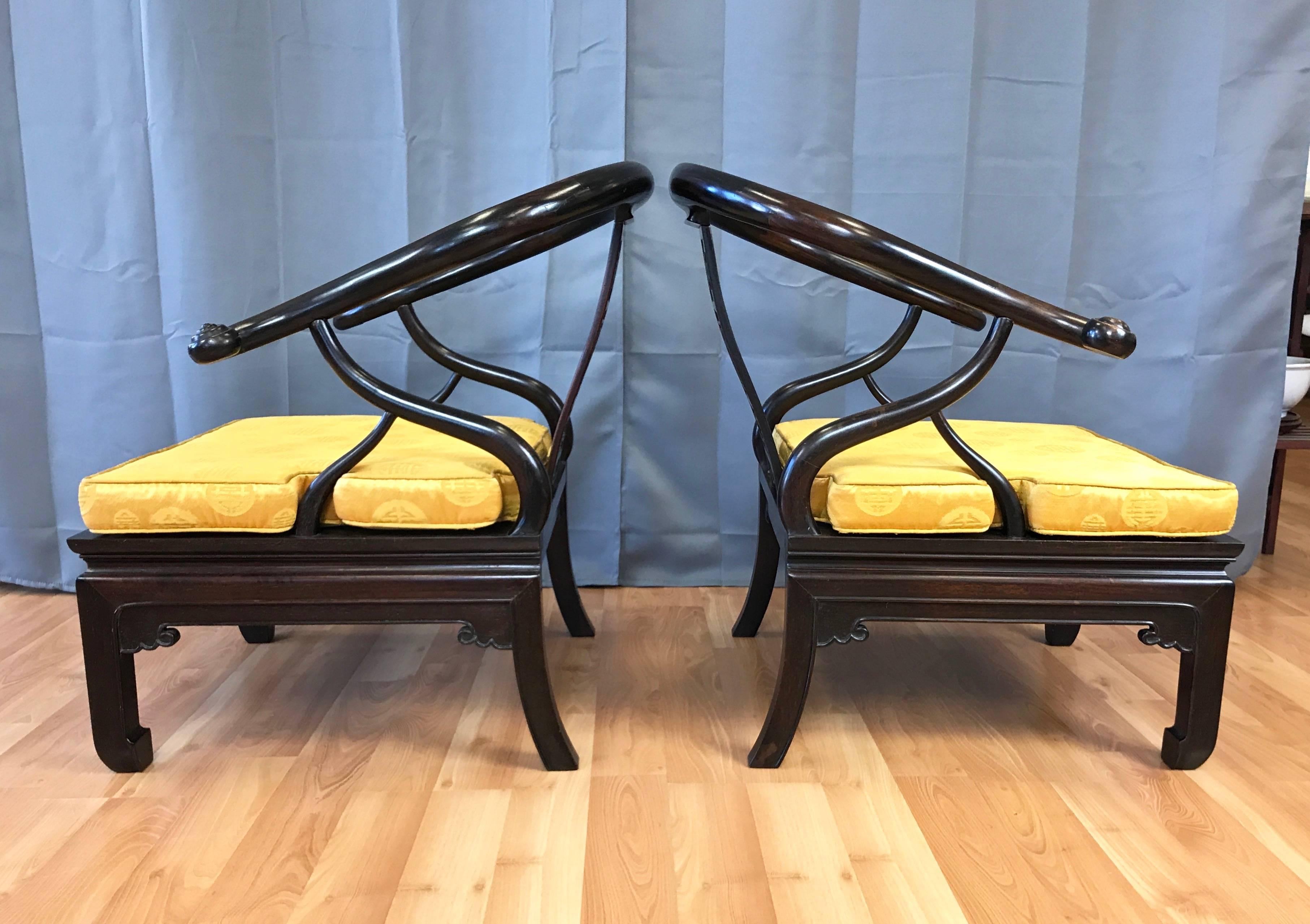 An exceptional pair of generously proportioned Chinese horseshoe chow chairs in stained solid rosewood, dating from shortly after the end of the Qing dynasty.

Sinuous back, arms and sides have an Art Nouveau feel. Skillfully-carved embellishments