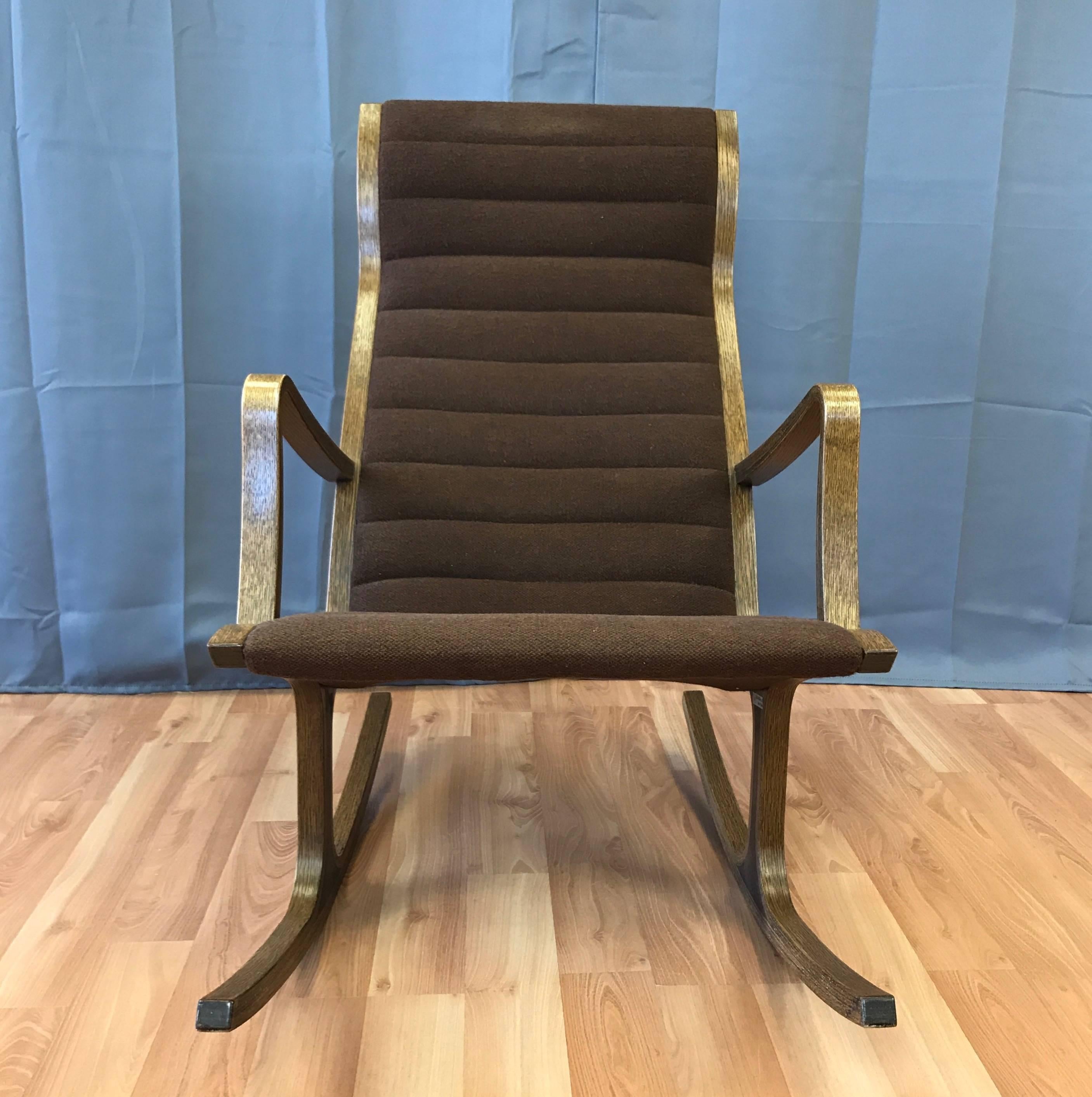 A Mid-Century Modern “Heron” high back rocking chair designed in 1966 by Mitsumasa Sugasawa for Tendo Mokko.

Bentwood oak frame and low profile upholstery strike a perfect balance between Minimalist lines and ergonomic comfort. Coffee-colored