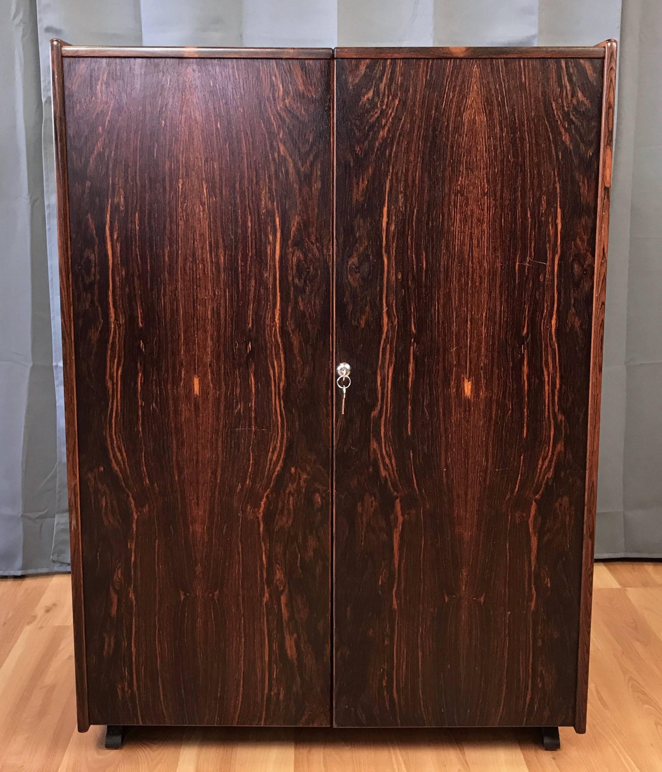 An extraordinary Danish modern “Magic Box” rosewood hide-away desk by Mummenthaler & Meier.

Designed in 1928, this circa 1970s Wooton-style desk cleverly conceals an on-demand office within an armoire-like cabinet. Exterior finished in strikingly