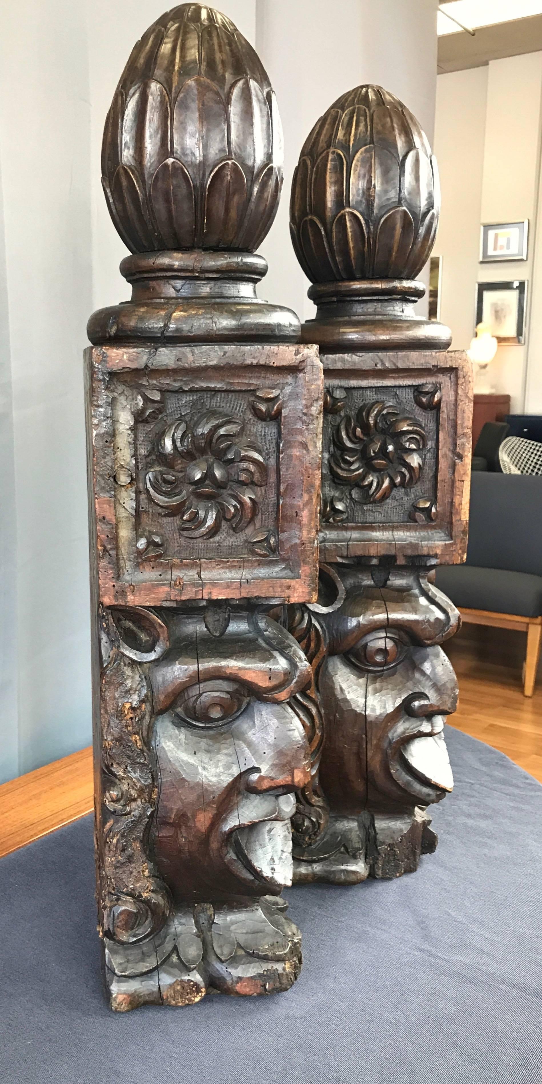 A pair of exceptionally large and expressive hand-carved solid mahogany newel posts from the early 1800s.

Of European origin, their uniquely commanding and captivating visage calls to mind a medieval-era gargoyle or a Maori warrior performing an
