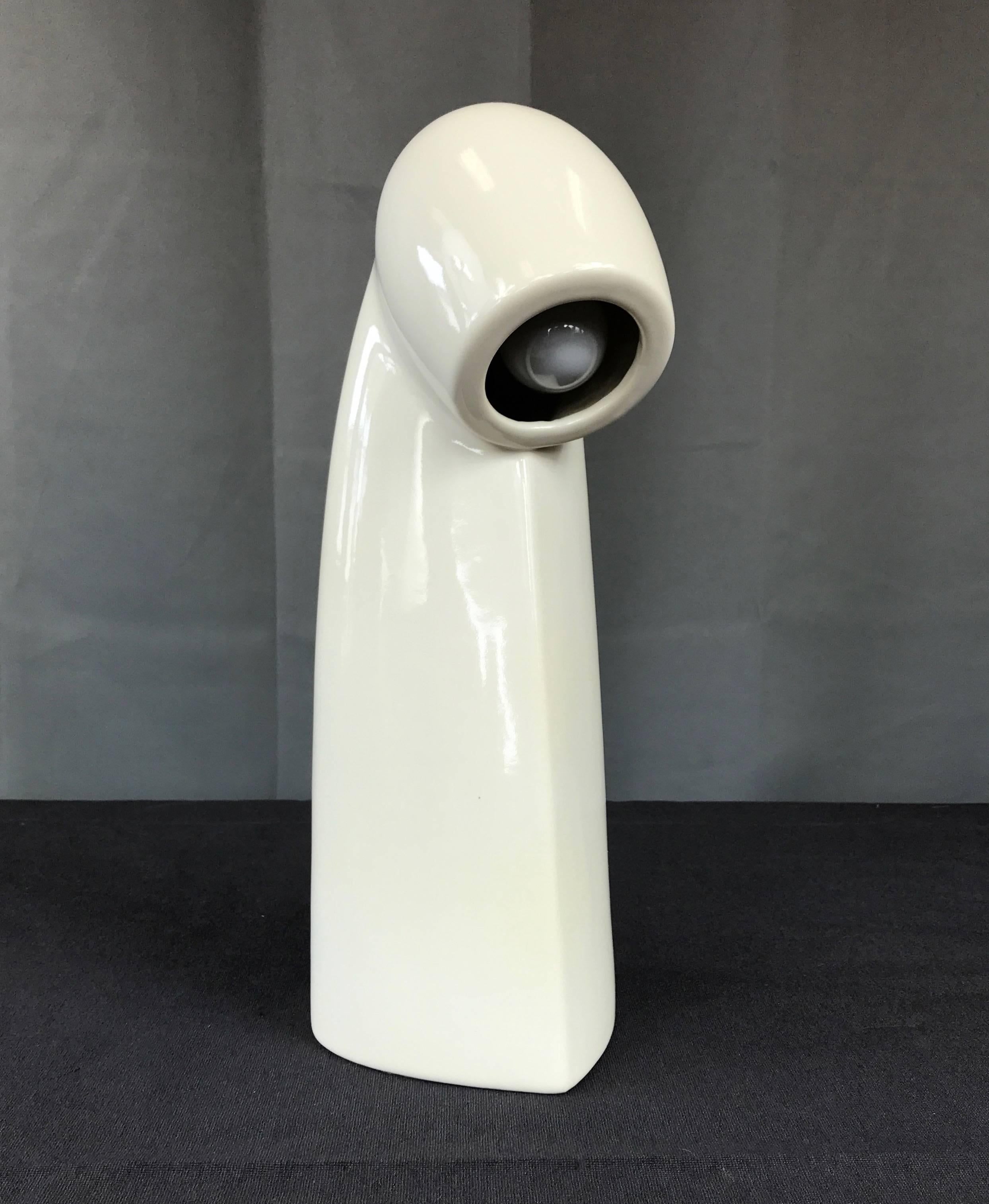 A vintage ceramic table or desk lamp done in the style of Gino Vistosi.

A sleek Mid-Century mix of mod and Space Age that would look right at home in a contemporary interior. Whether calling to mind a periscope, cloaked figure, or something from